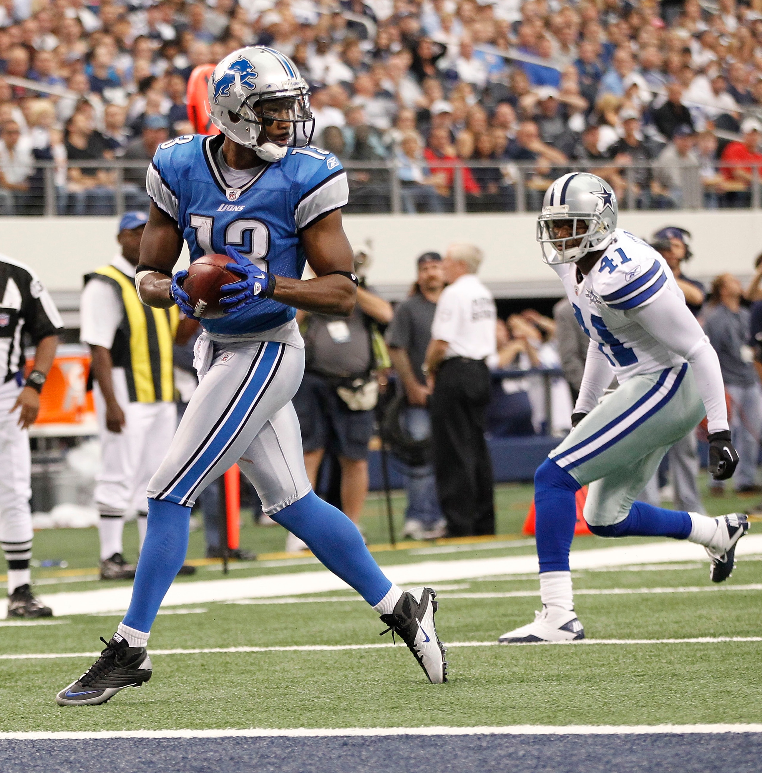 ARLINGTON, TX - NOVEMBER 21:  Nate Burleson #13 of the Detroit Lions scores a late second quarter touchdown as Terence Newman #41 of the Dallas Cowboys defends at Dallas Stadium on November 21, 2010 in Arlington, Texas.  (Photo by Leon Halip/Getty Images)