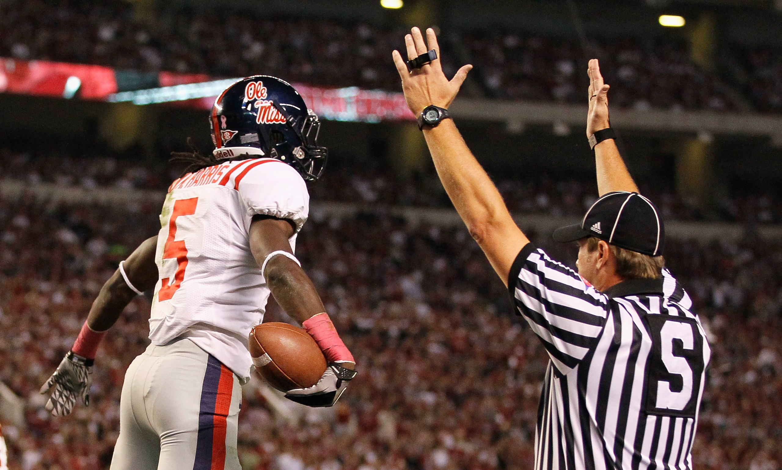 TUSCALOOSA, AL - OCTOBER 16:  Side judge Chris Jamison (R) signals a touchdown as Melvin Harris #5 of the Ole Miss Rebels reacts after scoring against the Alabama Crimson Tide at Bryant-Denny Stadium on October 16, 2010 in Tuscaloosa, Alabama.  (Photo by