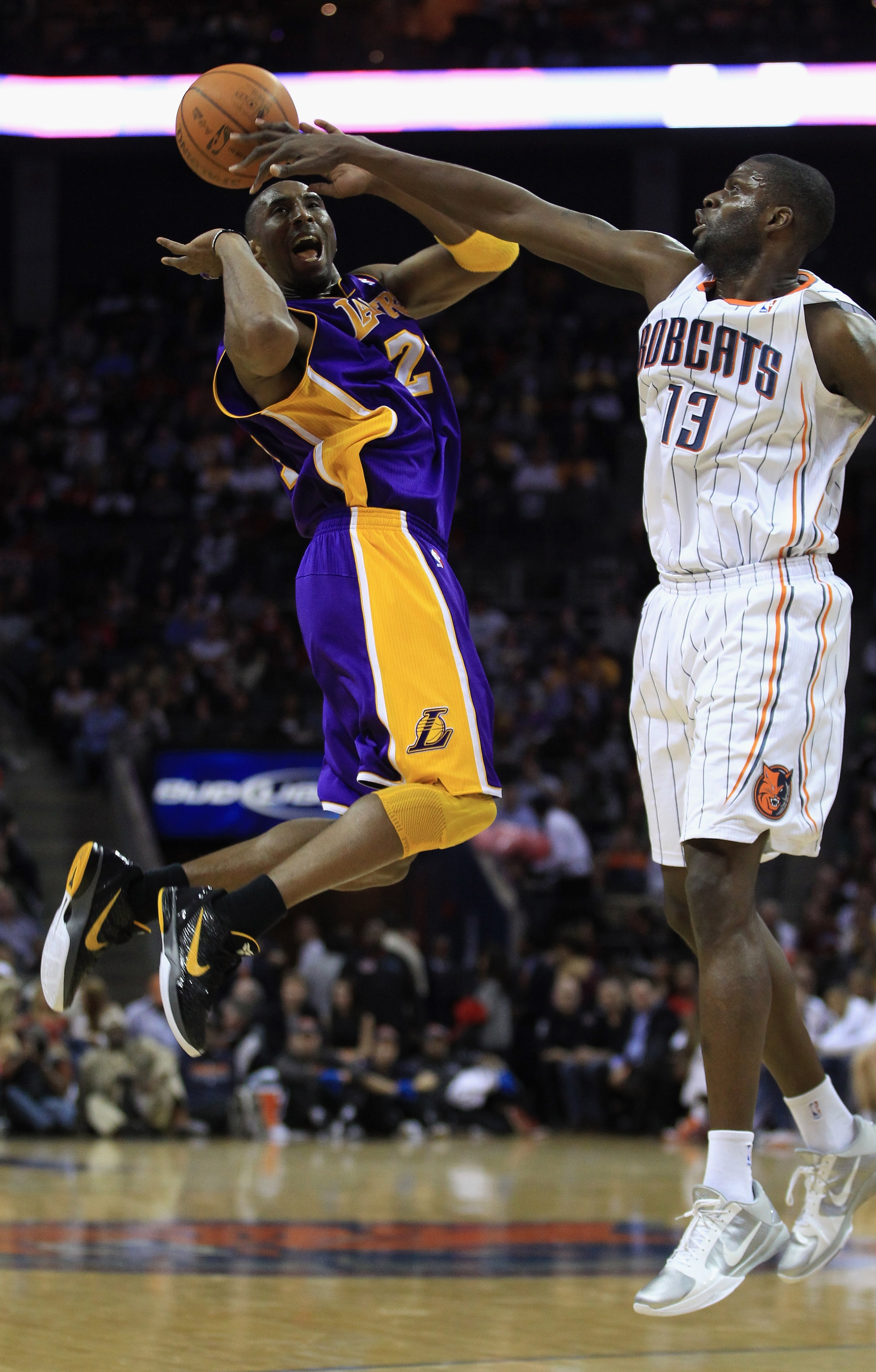 CHARLOTTE, NC - FEBRUARY 14:  Kobe Bryant #24 of the Los Angeles Lakers has the ball knocked loose by Nazr Mohammed #13 of the Charlotte Bobcats during their game at Time Warner Cable Arena on February 14, 2011 in Charlotte, North Carolina. NOTE TO USER: