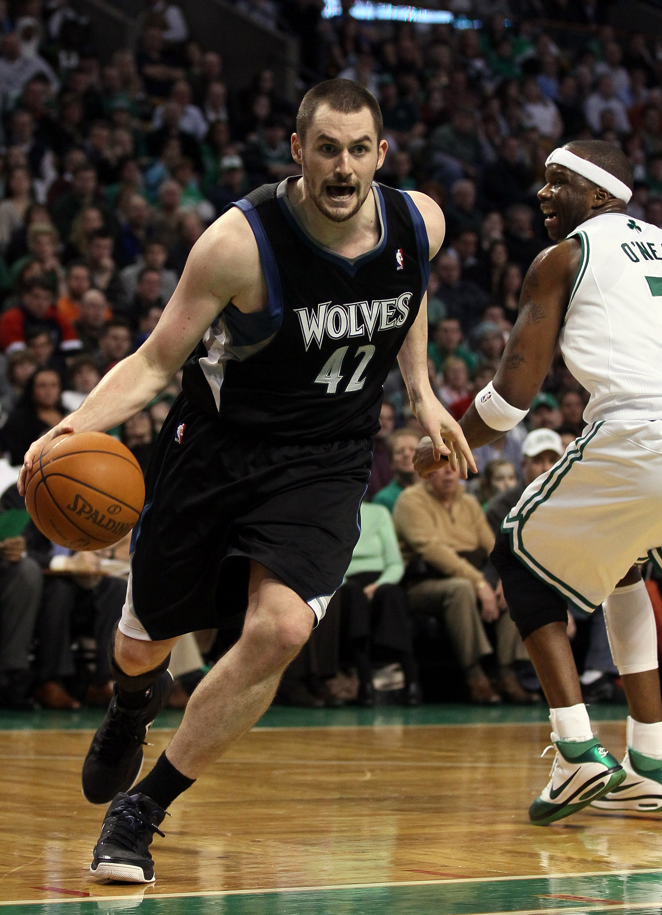 BOSTON, MA - JANUARY 03:  Kevin Love #42 of the Minnesota Timberwolves drives around Jermaine O'Neal #7 of the Boston Celtics on January 3, 2011 at the TD Garden in Boston, Massachusetts. The Celtics defeated the Timberwolves 96-93. NOTE TO USER: User exp