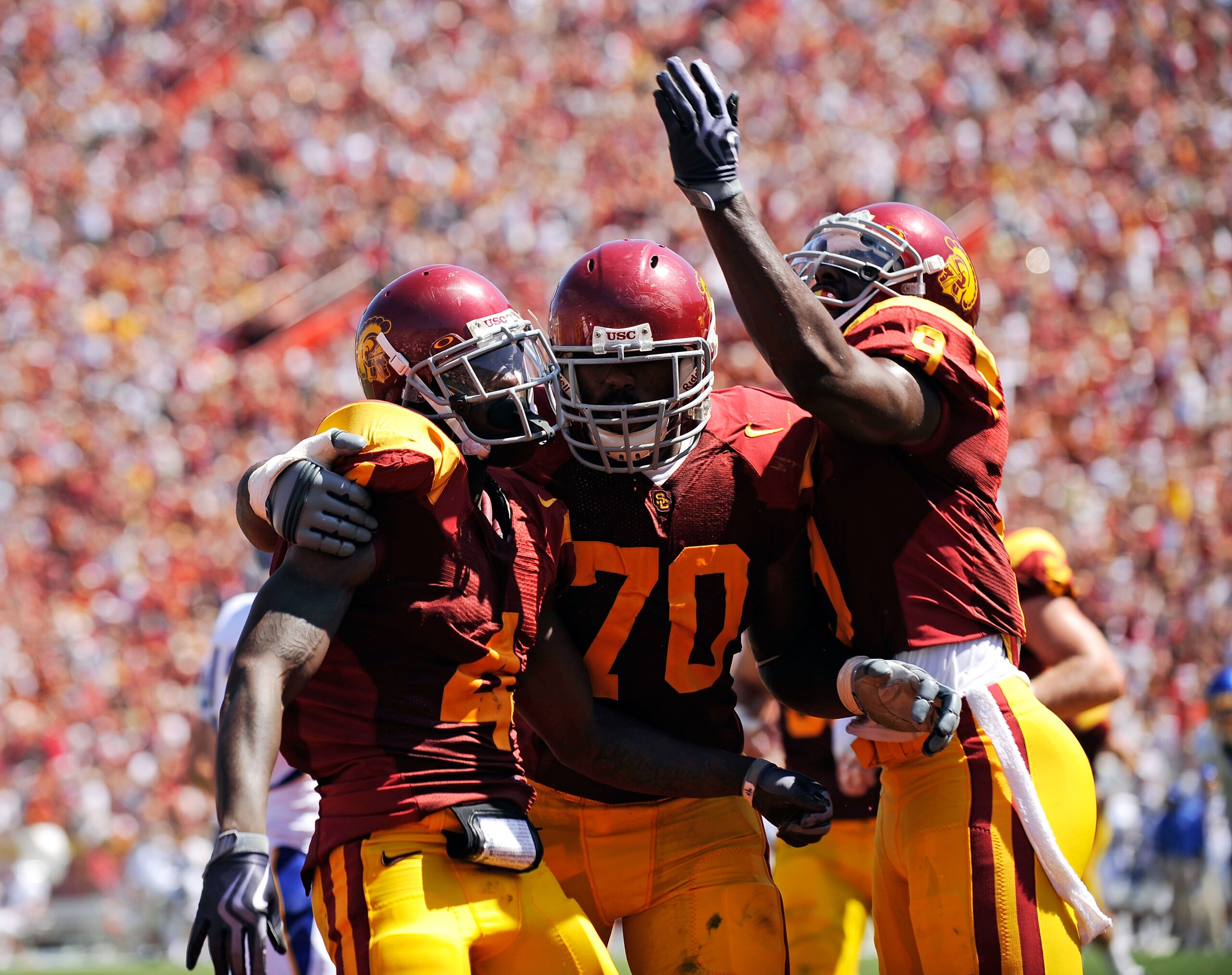 LOS ANGELES, CA - SEPTEMBER 05:  Joe McKnight #4 of the USC Trojans celebrates his touchdown with Tyron Smith #70 and David Ausberry #9 during the second quarter against the San Jose State Spartans at Los Angeles Memorial Coliseum on September 5, 2009 in