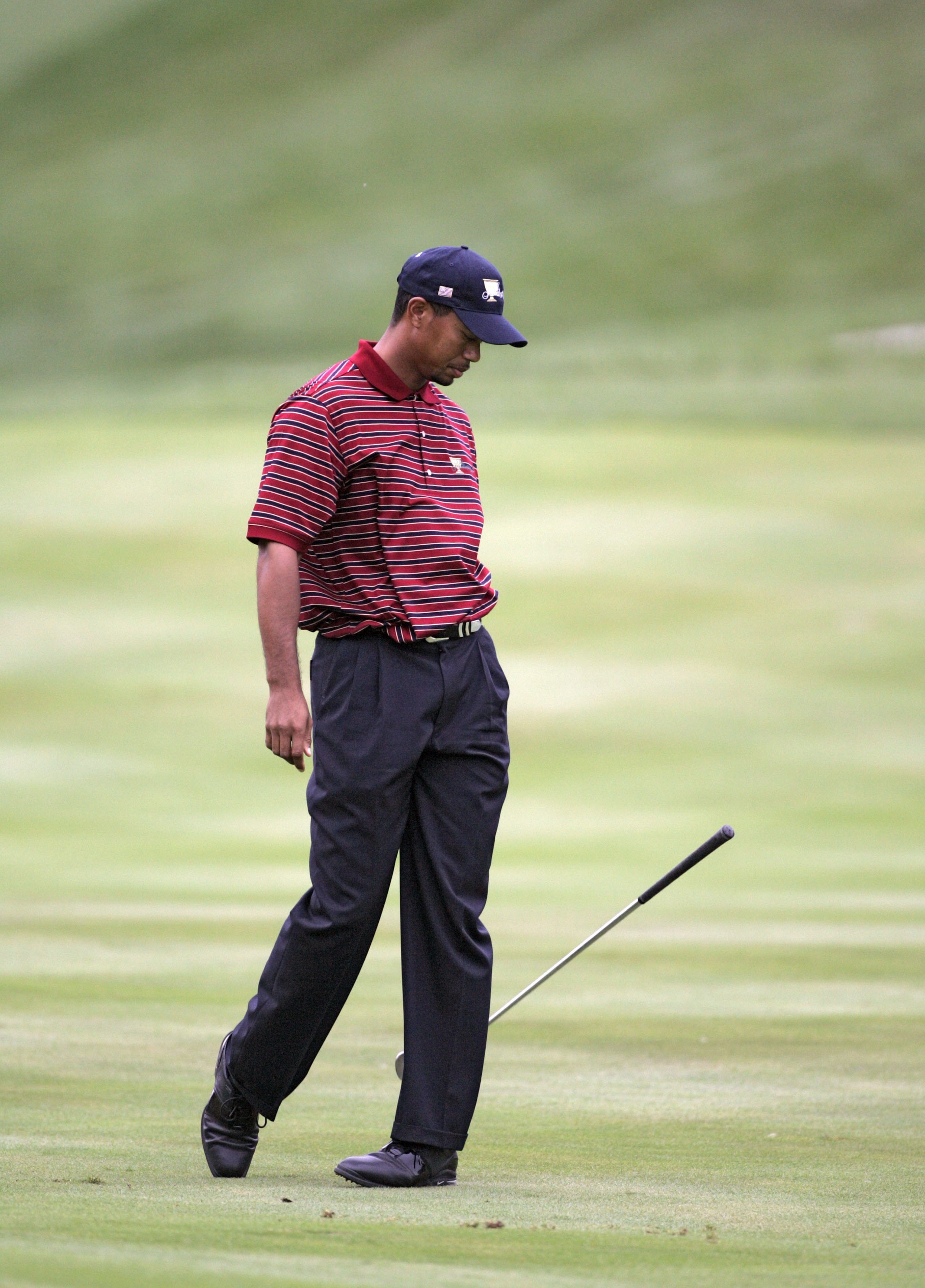 UNITED STATES - SEPTEMBER 24:  Tiger Woods of the U.S. team drops his club after a shot during the four-ball matches in the third round of The Presidents Cup at Robert Trent Jones Golf Club in Prince William County, Virginia on September 24, 2005.  (Photo