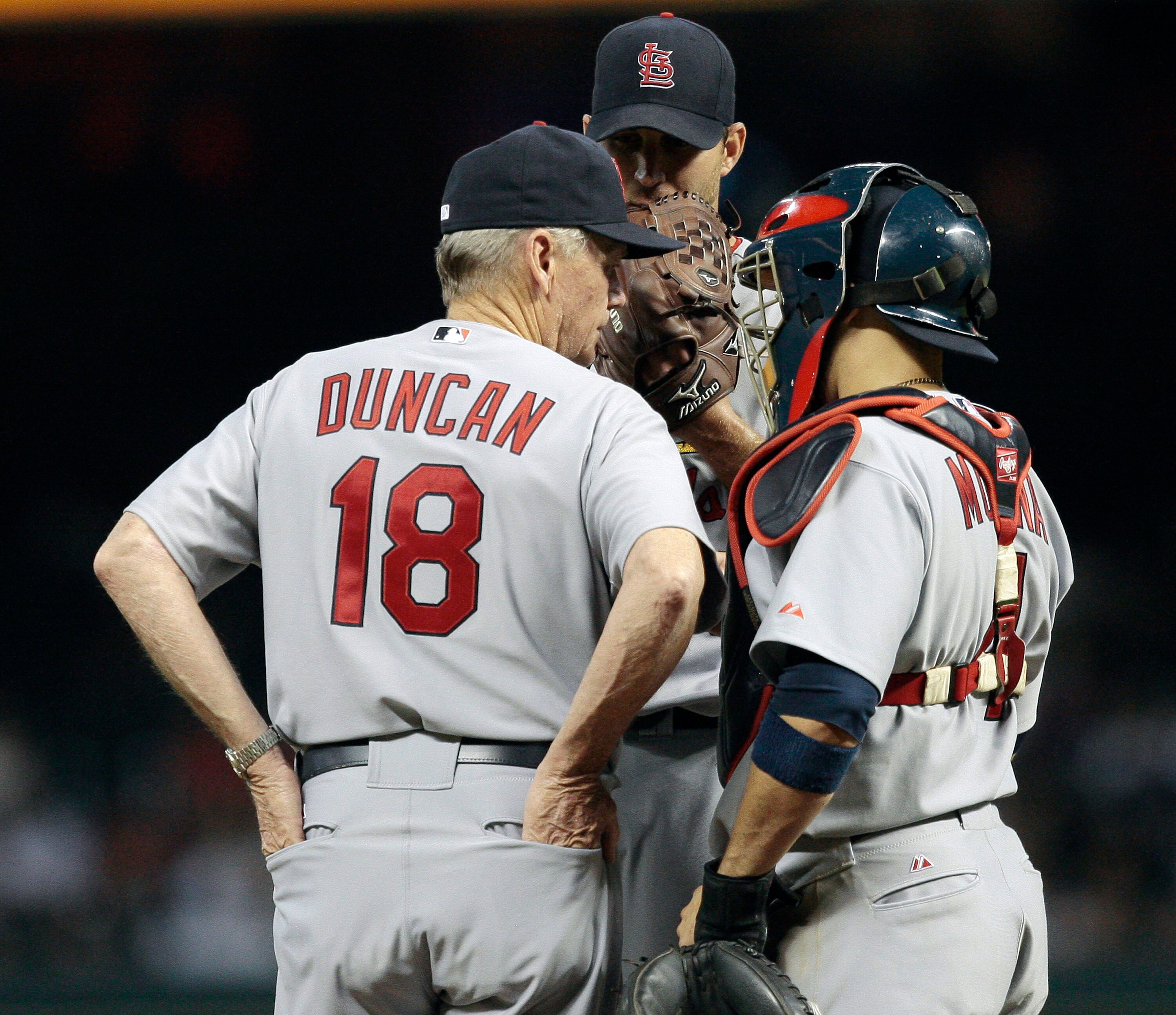 HOUSTON - JULY 09:  Pitching coach Dave Duncan #18 of the St. Louis Cardinals talks with pitcher Adam Wainwright #50 and catcher Yadier Molina #4 during a baseball game against the Houston Astros at Minute Maid Park on July 9, 2010 in Houston, Texas.  (Ph