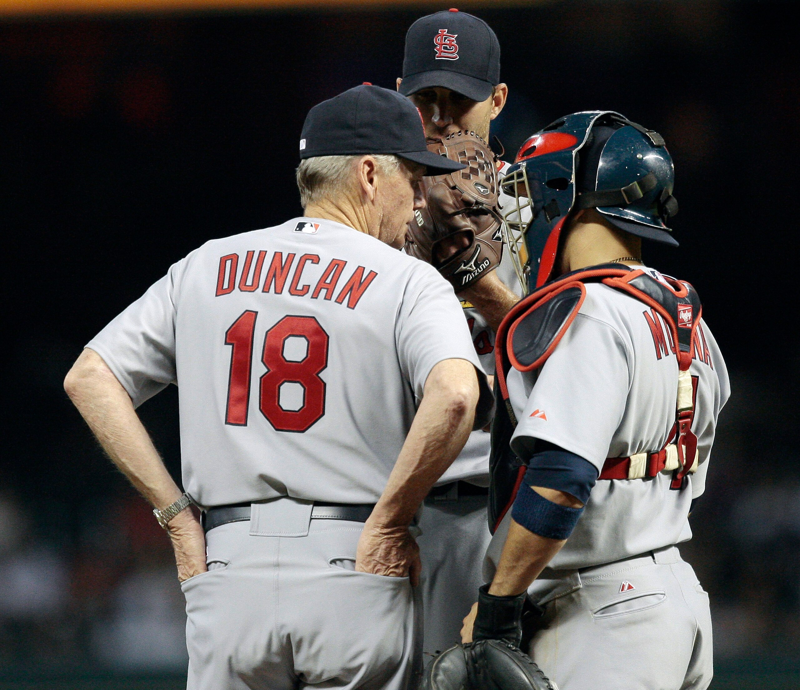 HOUSTON - JULY 09:  Pitching coach Dave Duncan #18 of the St. Louis Cardinals talks with pitcher Adam Wainwright #50 and catcher Yadier Molina #4 during a baseball game against the Houston Astros at Minute Maid Park on July 9, 2010 in Houston, Texas.  (Ph