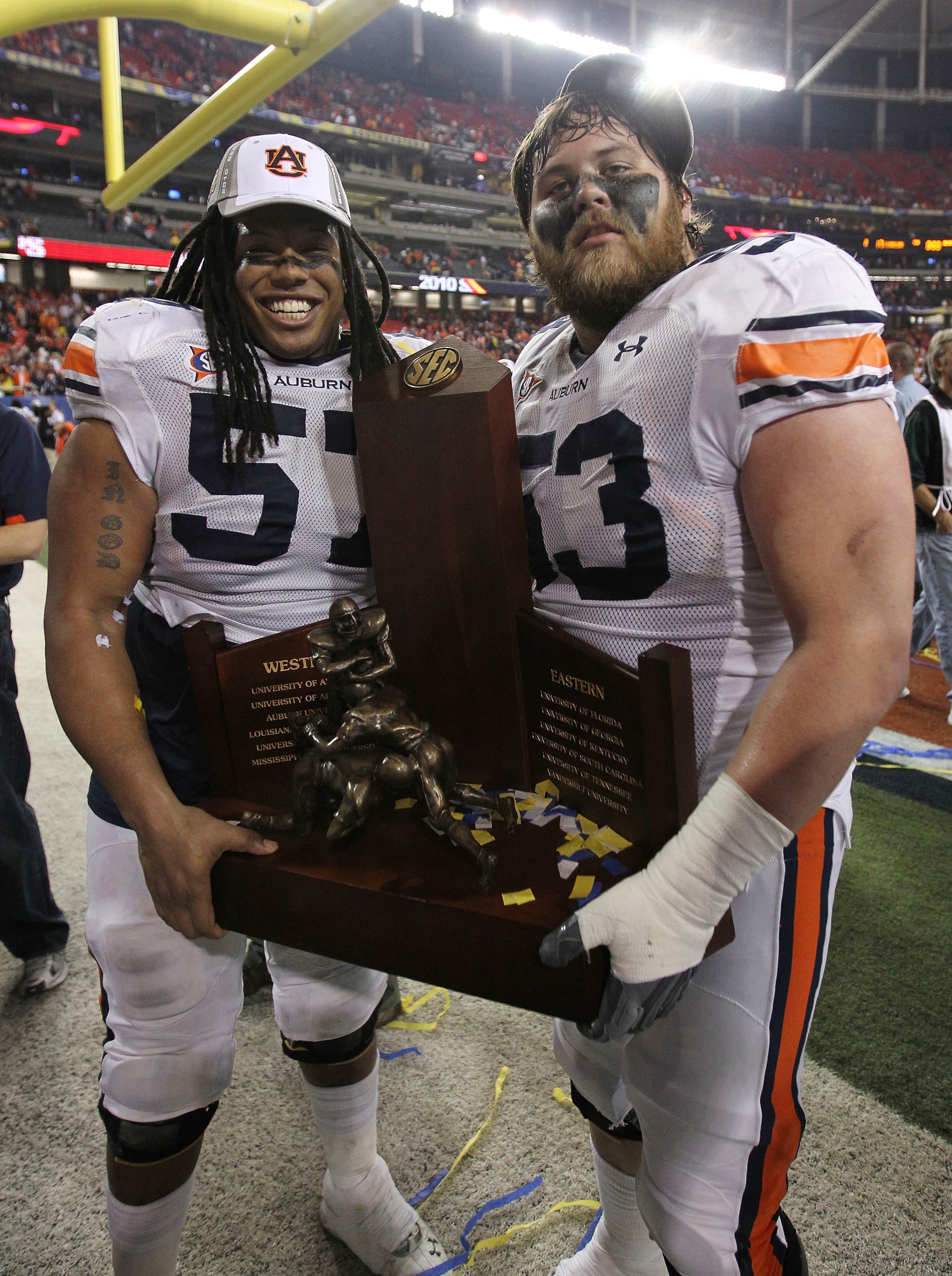 ATLANTA - DECEMBER 4: Lineman Bryon Isom #57 (left) and Bart Eddins #53 of the Auburn Tigers celebrate with the SEC Championship trophy after the 2010 SEC Championship against the South Carolina Gamecocks at Georgia Dome on December 4, 2010 in Atlanta, G ATLANTA - DECEMBER 4: Lineman Bryon Isom #57 (left) and Bart Eddins #53 of the Auburn Tigers celebrate with the SEC Championship trophy after the 2010 SEC Championship against the South Carolina Gamecocks at Georgia Dome on December 4, 2010 in Atlanta, G
