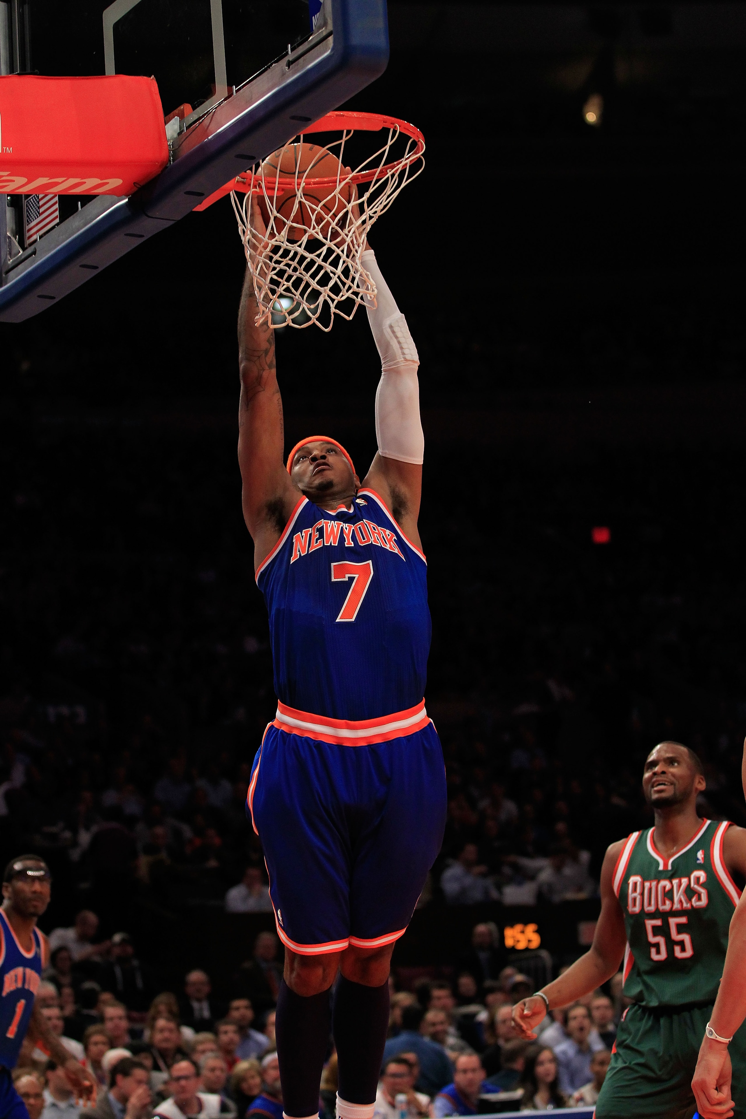 NEW YORK, NY - FEBRUARY 23:  Carmelo Anthony #7 of the New York Knicks dunks the ball over Keylon Dooling #55 of the Milwaukee Bucks at Madison Square Garden on February 23, 2011 in New York City. NOTE TO USER: User expressly acknowledges and agrees that,