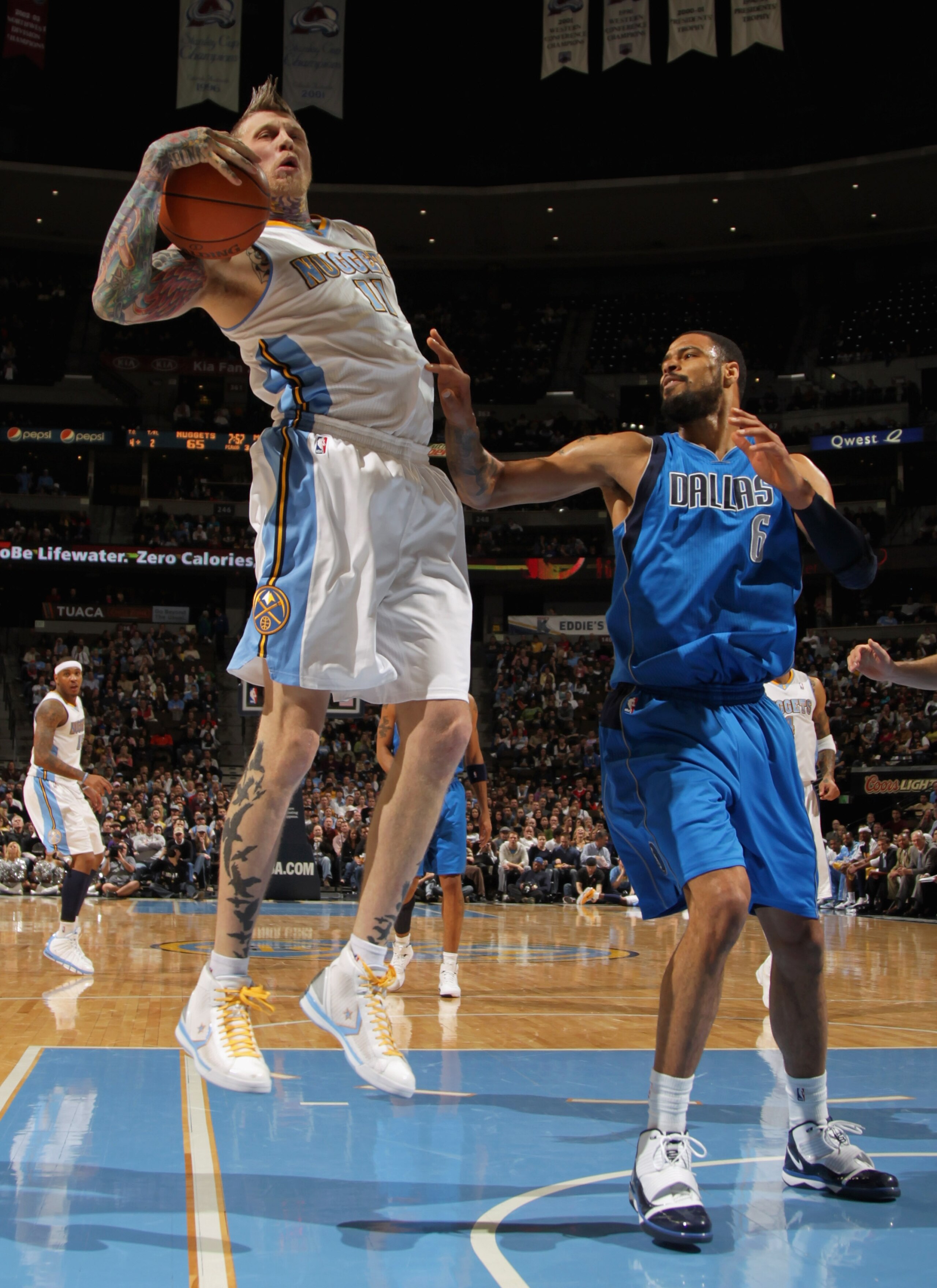 DENVER, CO - FEBRUARY 10:  Chris Andersen #11 of the Denver Nuggets grabs a rebound away from Tyson Chandler #6 of the Dallas Mavericks during NBA action at the Pepsi Center on February 10, 2011 in Denver, Colorado. The Nuggets defeated the Mavericks 121-