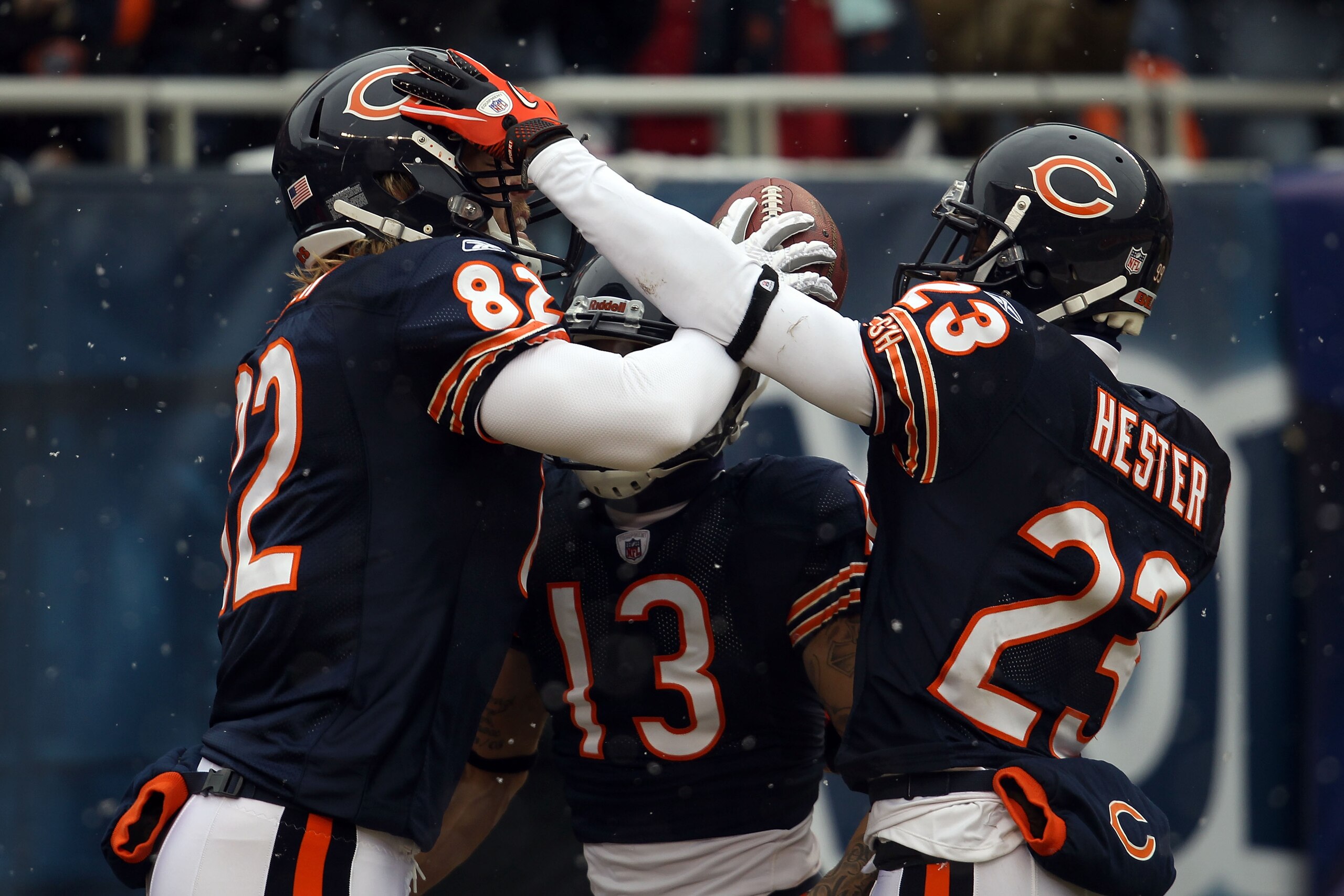 CHICAGO, IL - JANUARY 16:  Tight end Greg Olsen #82 of the Chicago Bears celebrates with Johnny Knox #13 and Devin Hester #23 after Olsen scores on a 58-yard touchdown reception in the first quarter against the Seattle Seahawks in the 2011 NFC divisional