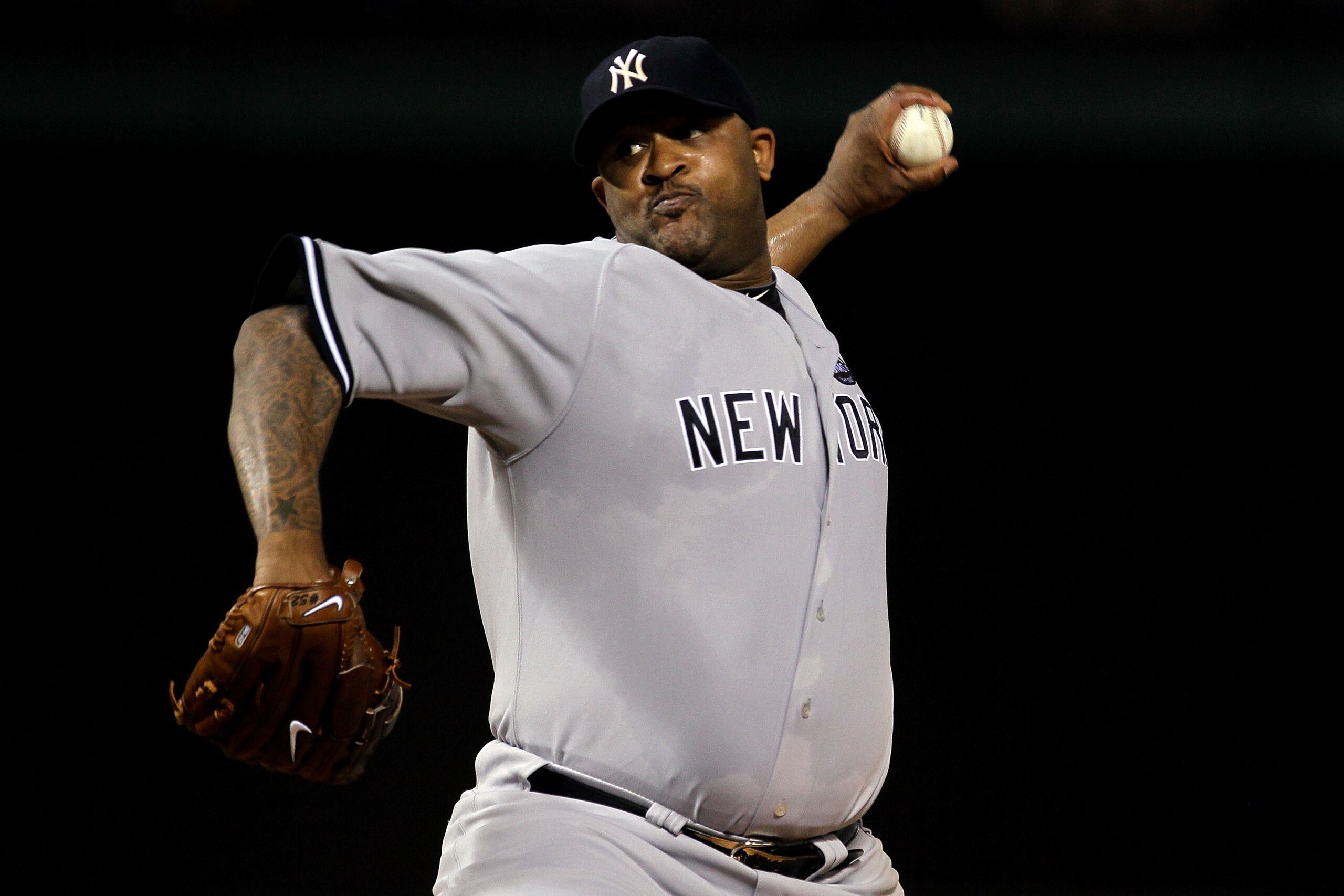 ARLINGTON, TX - OCTOBER 15: CC Sabithia #52 of the New York Yankees throws a pitch against the Texas Rangers in Game One of the ALCS during the 2010 MLB Playoffs at Rangers Ballpark in Arlington on October 15, 2010 in Arlington, Texas. (Photo by Stephen ARLINGTON, TX - OCTOBER 15: CC Sabithia #52 of the New York Yankees throws a pitch against the Texas Rangers in Game One of the ALCS during the 2010 MLB Playoffs at Rangers Ballpark in Arlington on October 15, 2010 in Arlington, Texas. (Photo by Stephen
