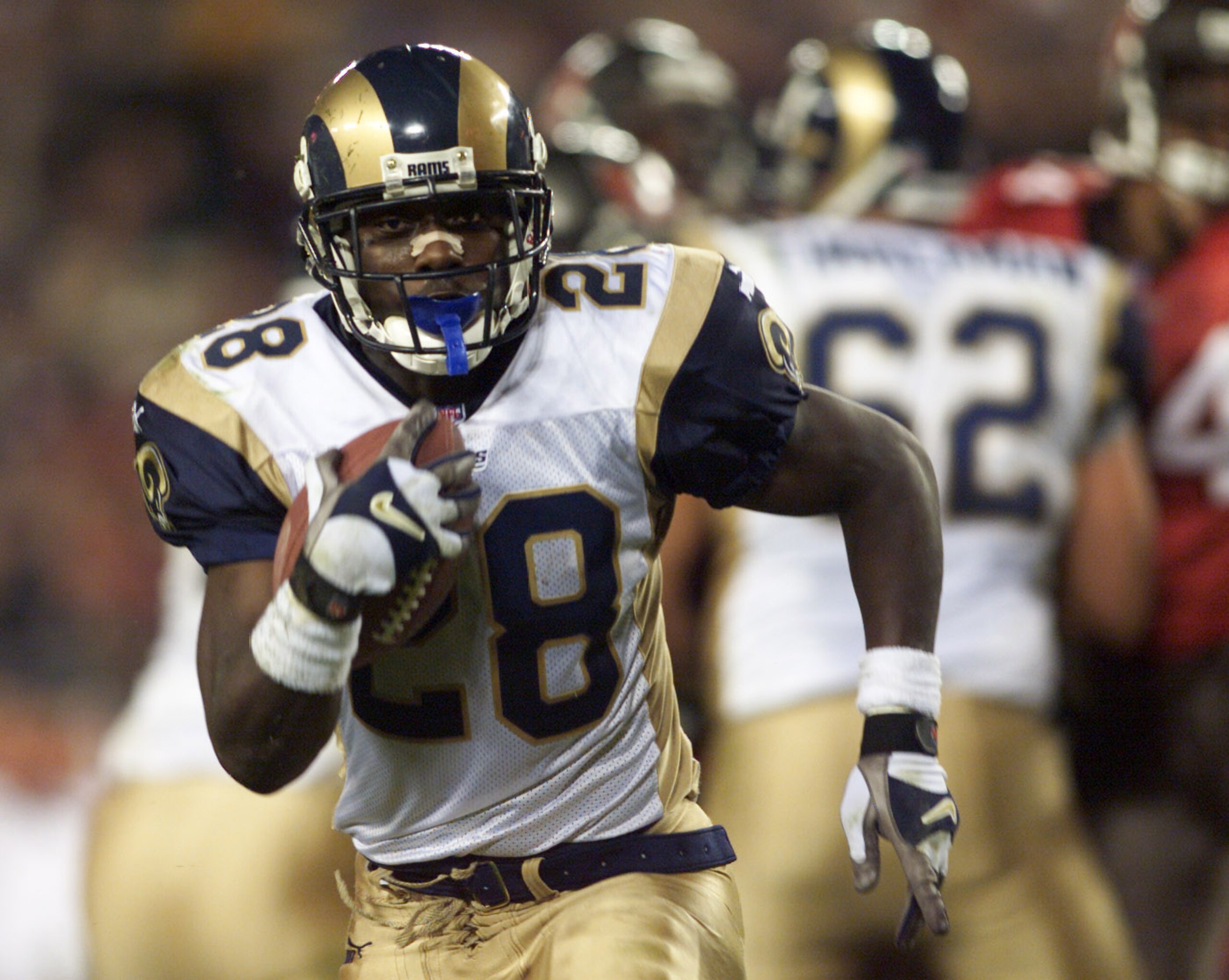 18 Dec 2000:  Marshall Faulk #28 of the St. Louis Rams scores a second quarter touchdown against against the Tampa Bay Buccaneers at Raymond James Stadium in Tampa, Florida. DIGITAL IMAGE. Mandatory Credit: Andy Lyons/ALLSPORT