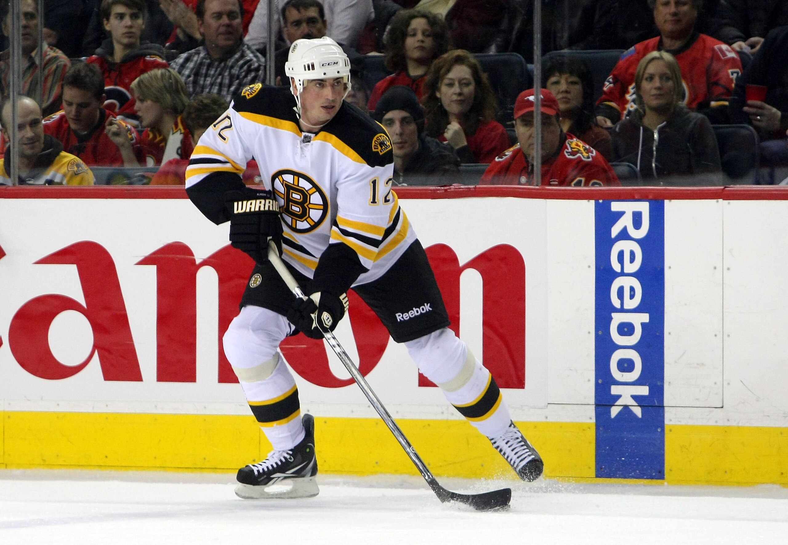 CALGARY,CANADA - FEBRUARY 22:  Tomas Kaberle #12 of the Boston Bruins carries the puck against the Calgary Flames during their NHL game at Scotiabank Saddledome, February 22,2011 in Calgary, Alberta, Canada.  (Photo By Dave Sandford/Getty Images)