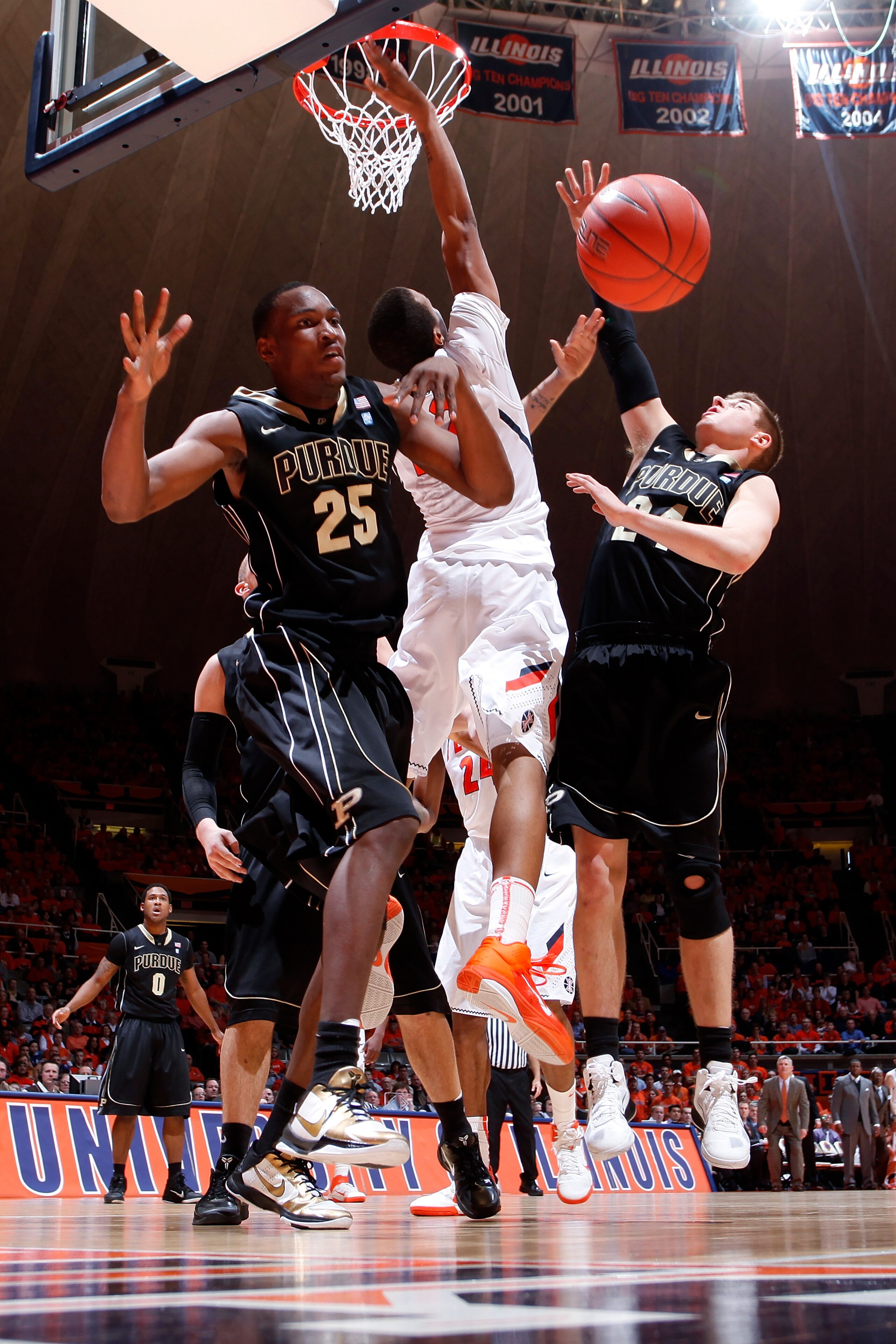 CHAMPAIGN, IL - FEBRUARY 13: JaJuan Johnson #25 and Ryne Smith #24 of the Purdue Boilermakers defend a shot by Jereme Richmond #22 of the Illinois Fighting Illini at Assembly Hall on February 13, 2011 in Champaign, Illinois. Purdue defeated Illinois 81-70 CHAMPAIGN, IL - FEBRUARY 13: JaJuan Johnson #25 and Ryne Smith #24 of the Purdue Boilermakers defend a shot by Jereme Richmond #22 of the Illinois Fighting Illini at Assembly Hall on February 13, 2011 in Champaign, Illinois. Purdue defeated Illinois 81-70