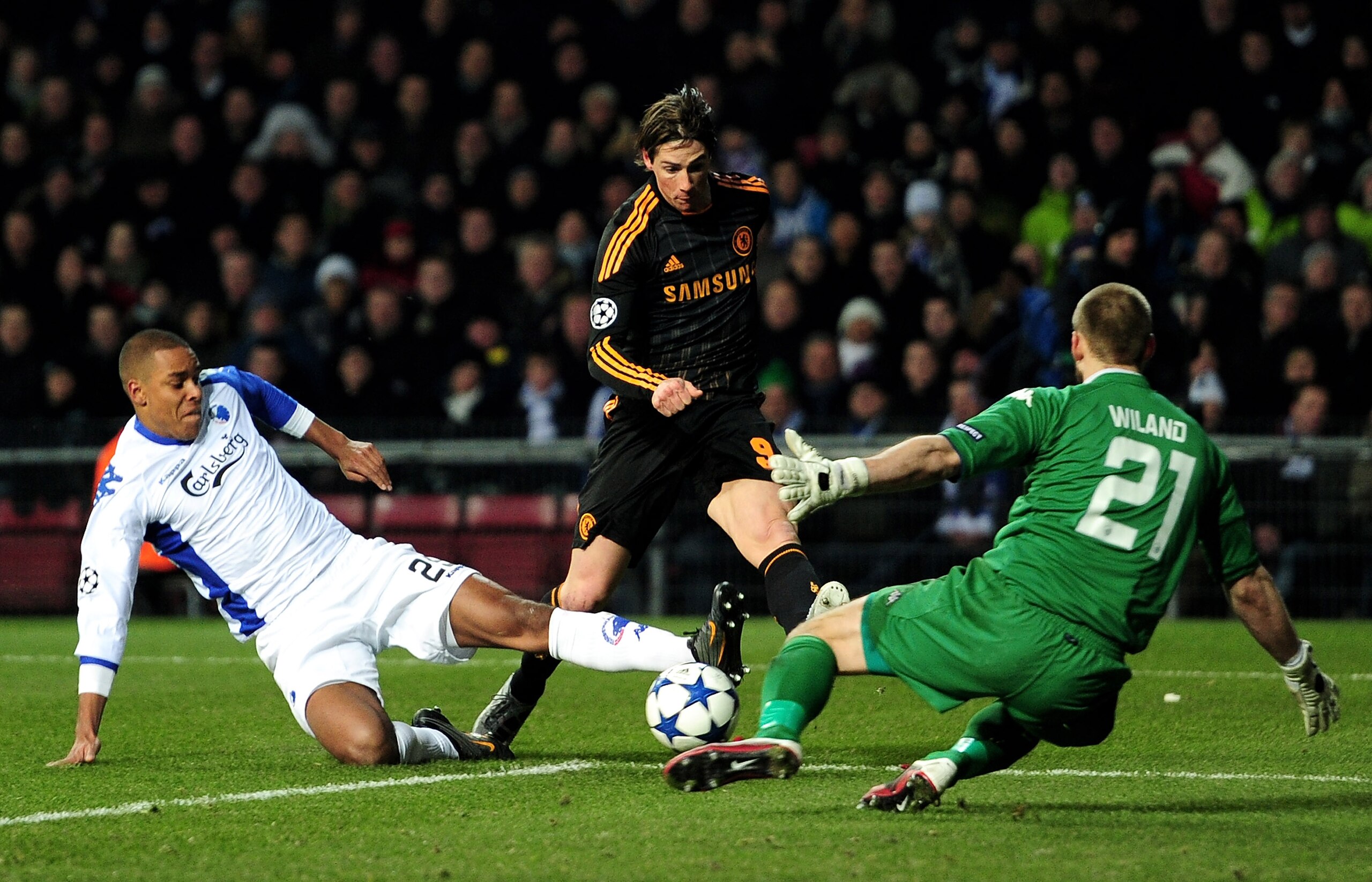 COPENHAGEN, DENMARK - FEBRUARY 22: Fernando Torres of Chelsea is challenged by Mathias Zanka Jorgensen (L) and Johan Wiland of FC Copenhagen during the UEFA Champions League round of 16 first leg match between FC Copenhagen and Chelsea at Parken Stadium COPENHAGEN, DENMARK - FEBRUARY 22: Fernando Torres of Chelsea is challenged by Mathias Zanka Jorgensen (L) and Johan Wiland of FC Copenhagen during the UEFA Champions League round of 16 first leg match between FC Copenhagen and Chelsea at Parken Stadium