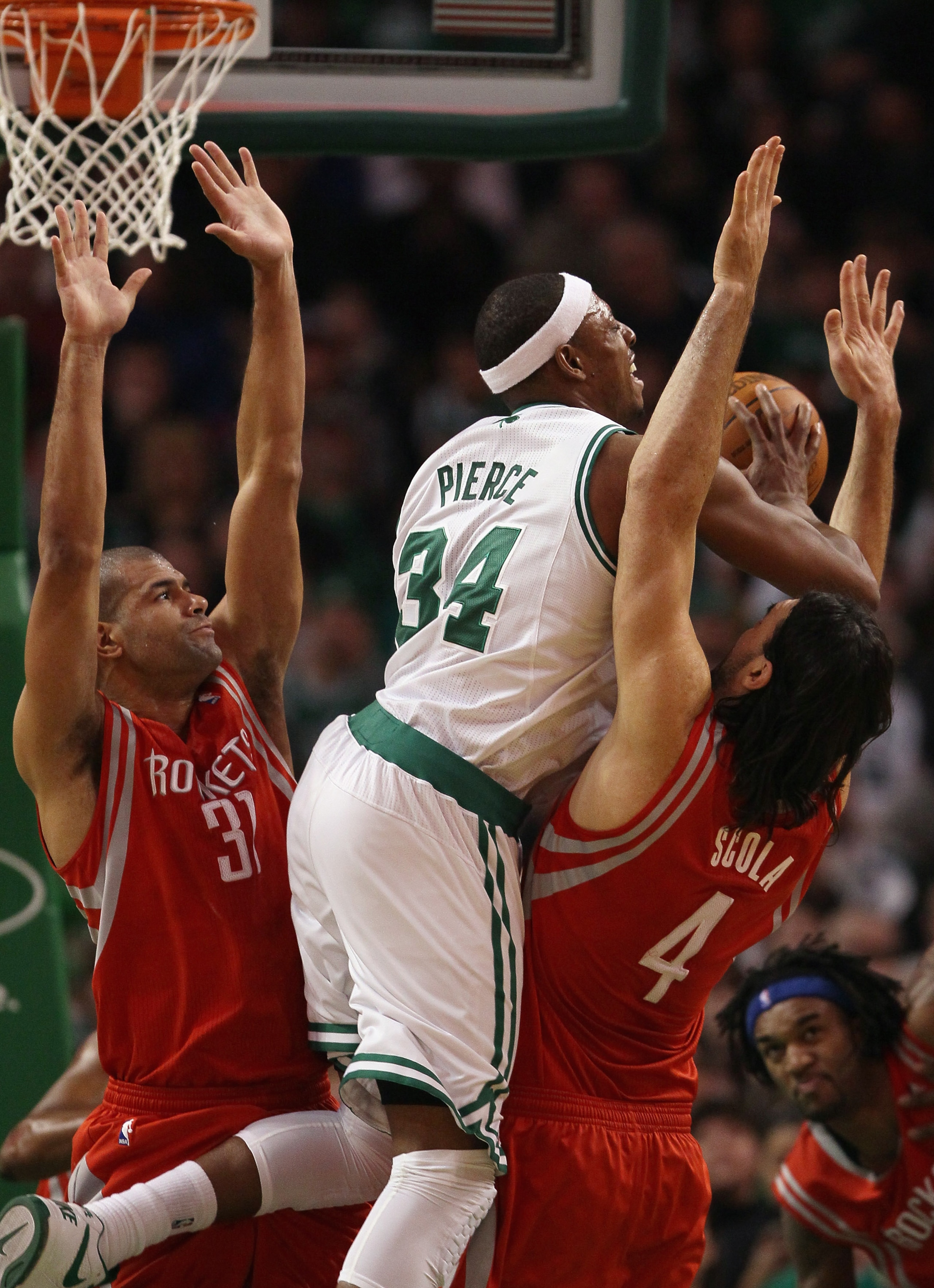 BOSTON, MA - JANUARY 10:  Paul Pierce #34 of the Boston Celtics tries to pass the ball as Shane Battier #31 and Luis Scola #4 of the Houston Rockets defend on January 10, 2011 at the TD Garden in Boston, Massachusetts.  The Rockets defeated the Celtics 10