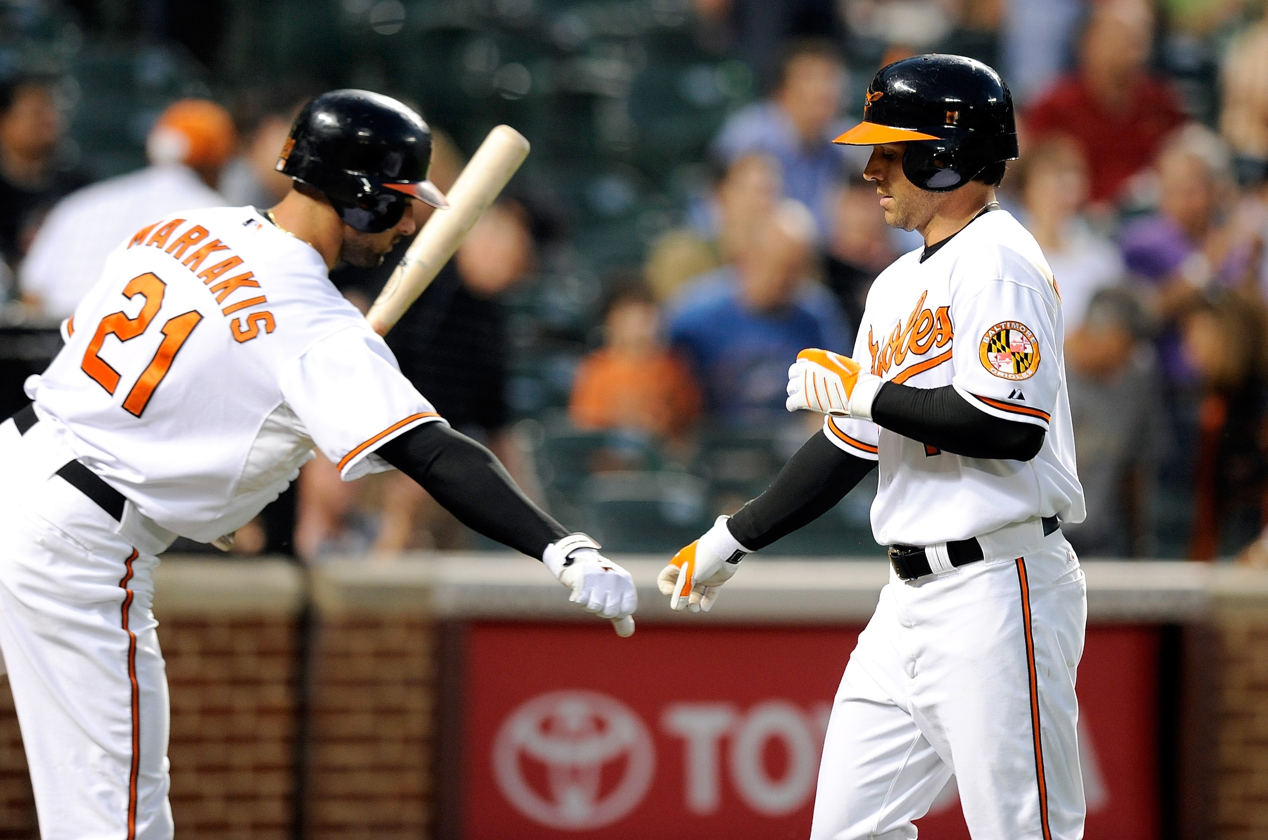 BALTIMORE - SEPTEMBER 13:  Brian Roberts #1 of the Baltimore Orioles is congratulated by Nick Markakis #21 after hitting a home run in the first inning against the Toronto Blue Jays at Camden Yards on September 13, 2010 in Baltimore, Maryland.  (Photo by