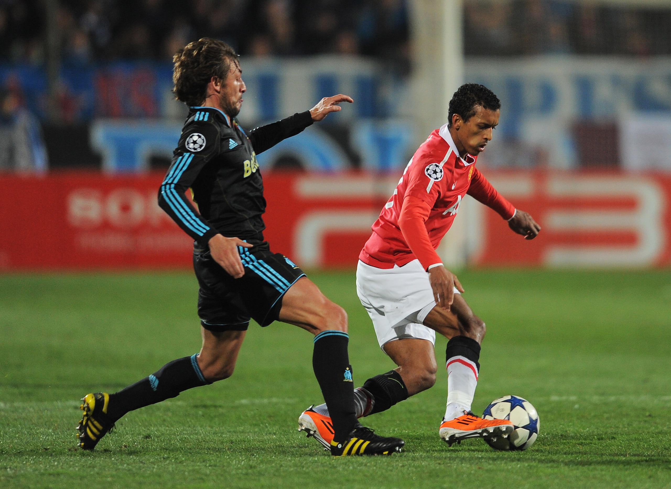 MARSEILLE, FRANCE - FEBRUARY 23: Nani of Manchester United takes the ball past Gabriel Heinze of Marseille during the UEFA Champions League round of 16 first leg match between Marseille and Manchester United at the Stade Velodrome on February 23, 2011 in MARSEILLE, FRANCE - FEBRUARY 23: Nani of Manchester United takes the ball past Gabriel Heinze of Marseille during the UEFA Champions League round of 16 first leg match between Marseille and Manchester United at the Stade Velodrome on February 23, 2011 in