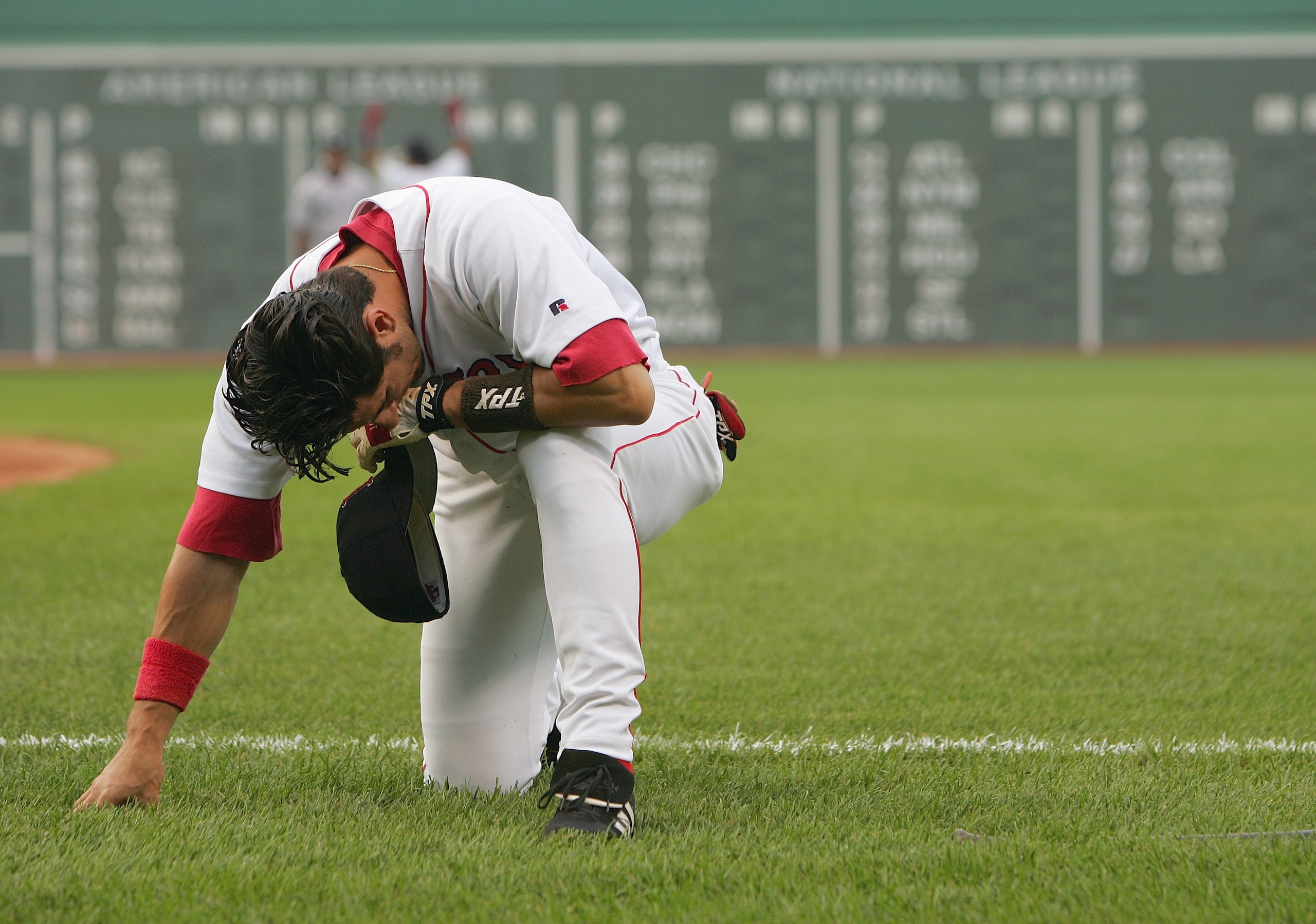 BOSTON - JULY 23:  Nomar Garciaparra #5 of the Boston Red Sox goes down to one knee dejected during the game against the New York Yankees at Fenway Park on July 23, 2004 in Boston, Massachusetts.  The Yankees defeated the Red Sox 8-7.  (Photo by Ezra Shaw