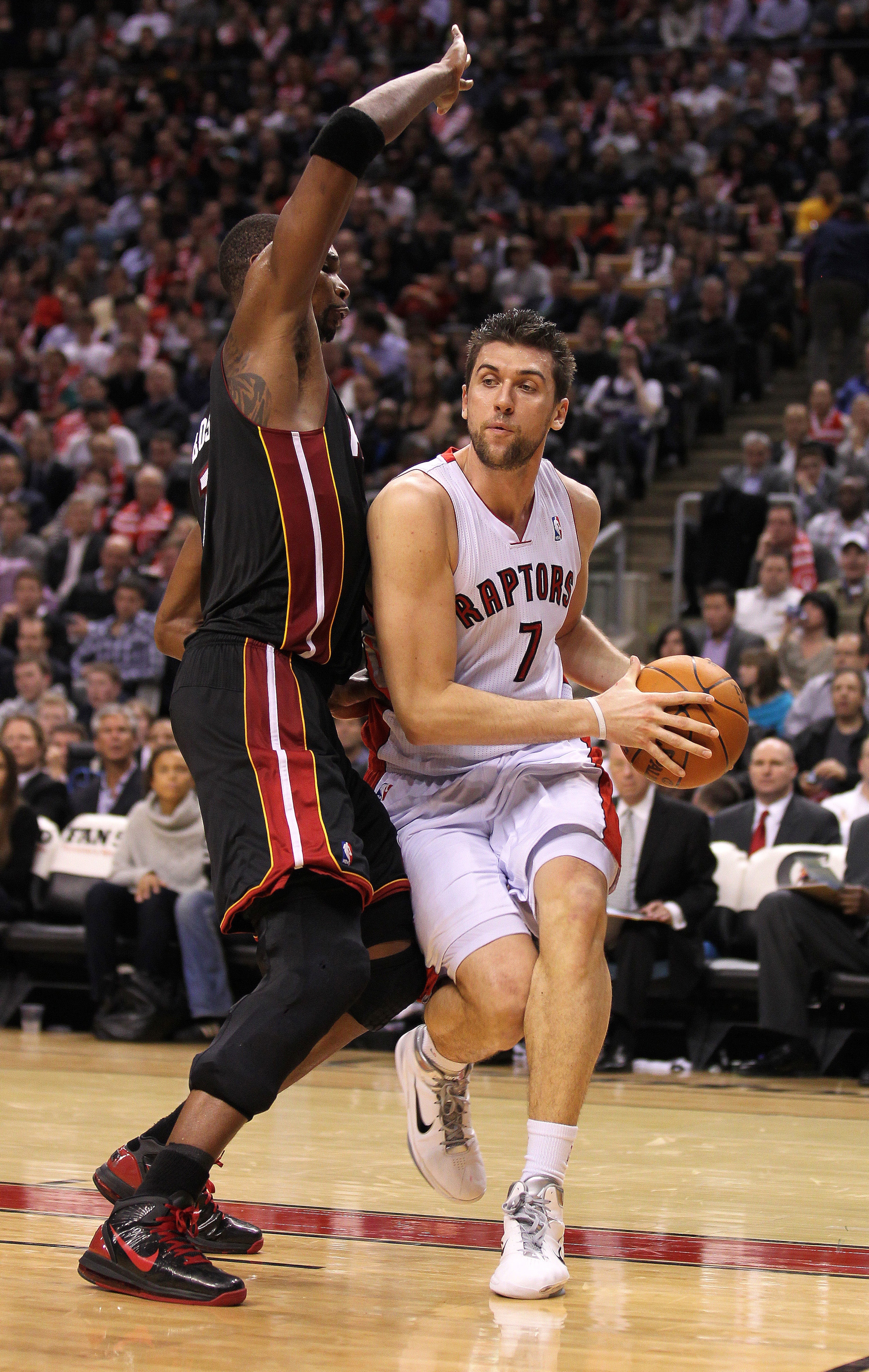 TORONTO, CANADA - FEBRUARY 16:  Chris Bosh #1 of the Miami Heat tries to defend against Andrea Bargnani #7 of the Toronto Raptors in a game on February 16, 2011 at the Air Canada Centre in Toronto, Canada. The Heat defeated the Raptors 103-95. (Photo by C