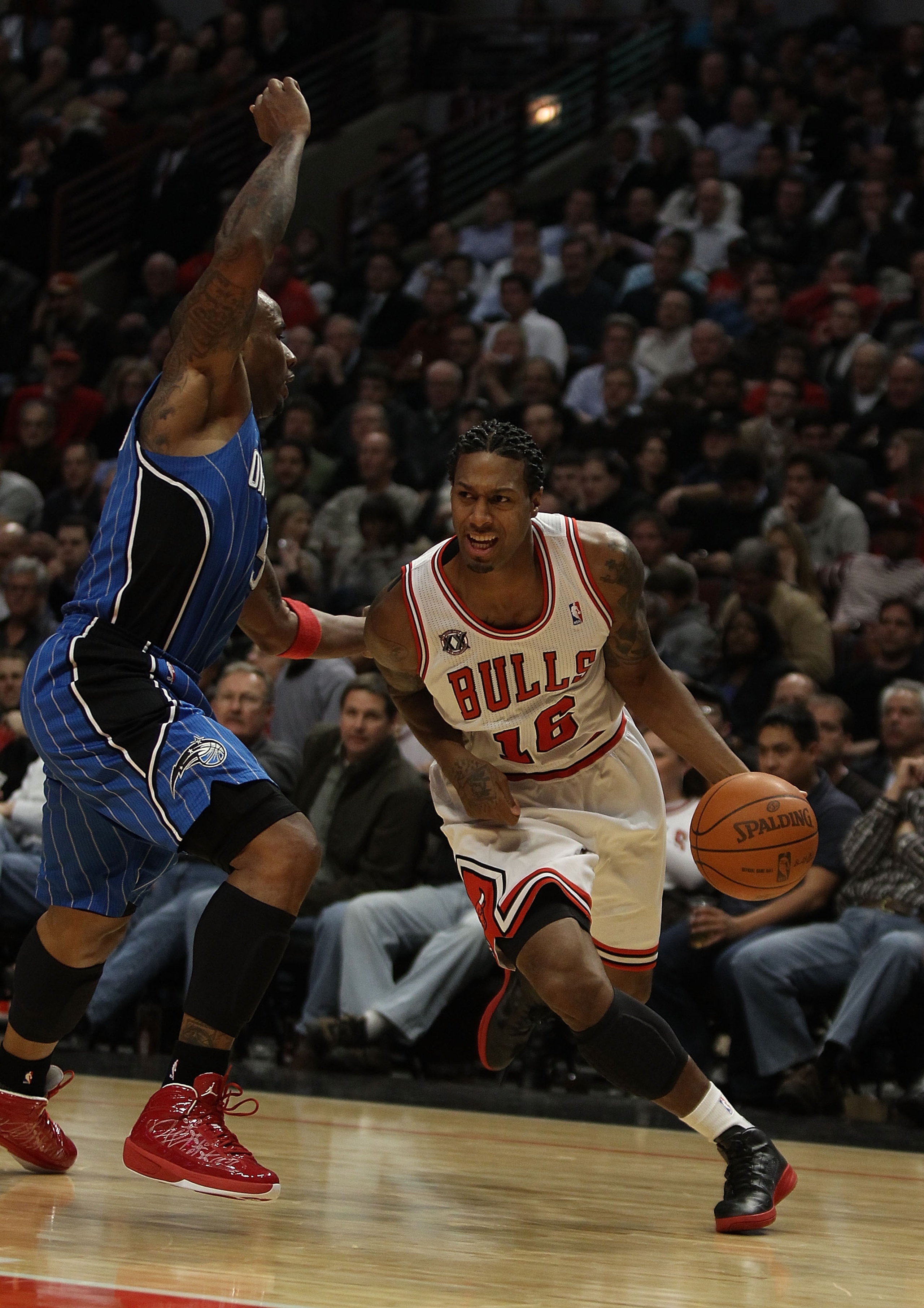 CHICAGO, IL - DECEMBER 01: James Johnson #16 of the Chicago Bulls drives around Jameer Nelson #14 of the Orlando Magic at the United Center on December 1, 2010 in Chicago, Illinois. The Magic defeated the Bulls 107-78. NOTE TO USER: User expressly acknowl