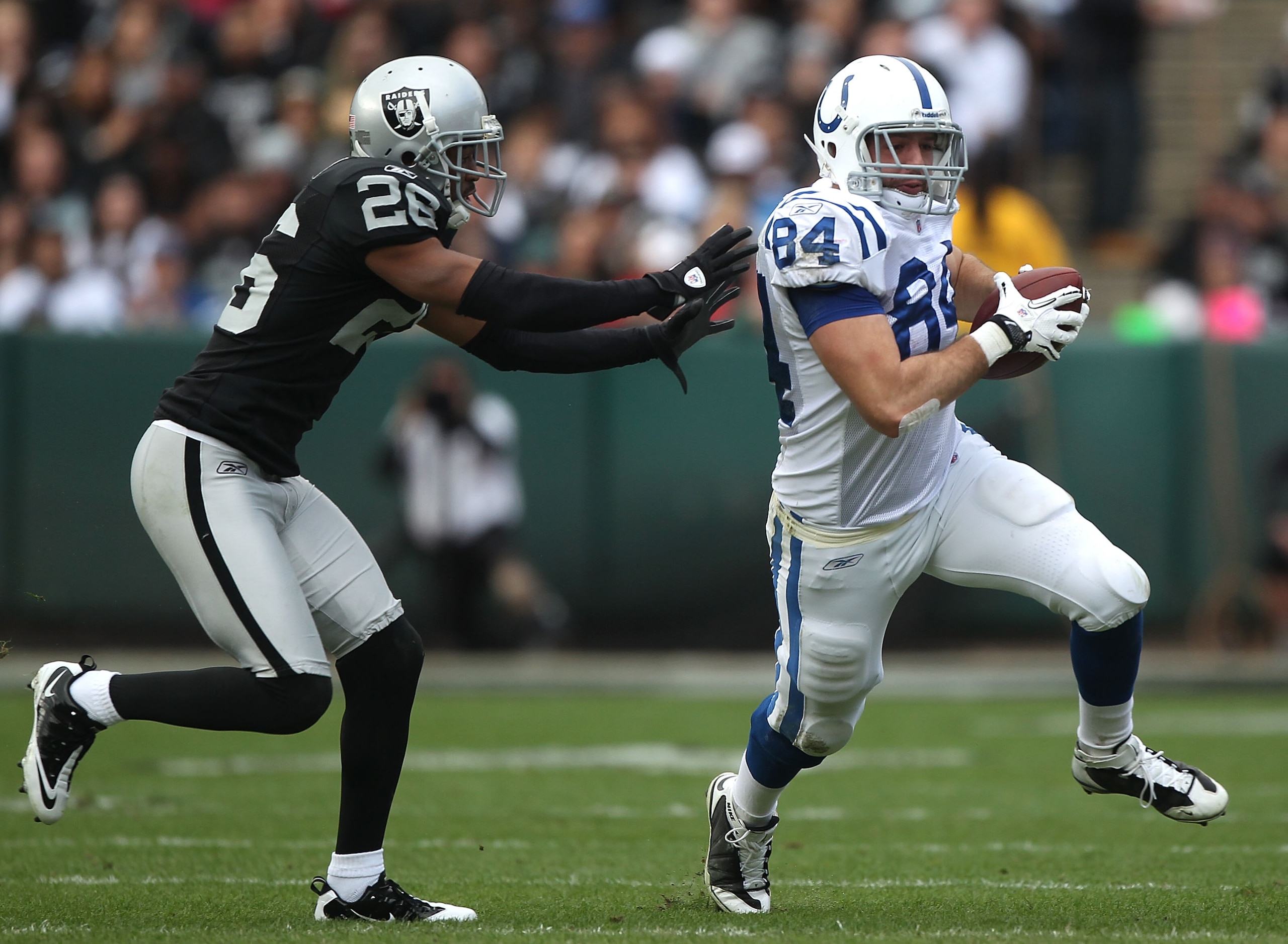 OAKLAND, CA - DECEMBER 26: Jacob Tamme #84 of the Indianapolis Colts runs after a catch past Stanford Routt #26 of the Oakland Raiders during an NFL game at Oakland-Alameda County Coliseum on December 26, 2010 in Oakland, California. (Photo by Jed Jaco OAKLAND, CA - DECEMBER 26: Jacob Tamme #84 of the Indianapolis Colts runs after a catch past Stanford Routt #26 of the Oakland Raiders during an NFL game at Oakland-Alameda County Coliseum on December 26, 2010 in Oakland, California. (Photo by Jed Jaco