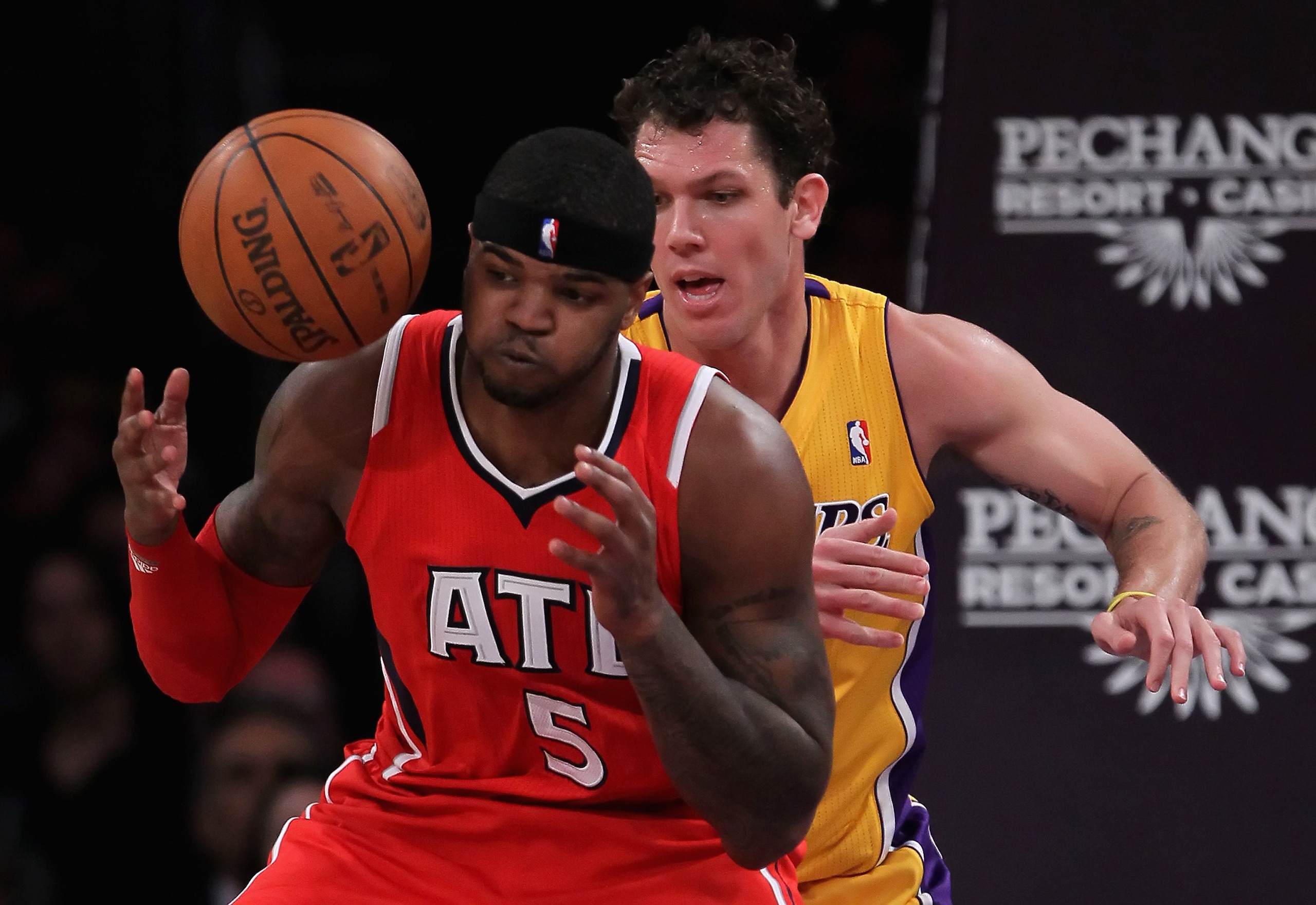 LOS ANGELES, CA - FEBRUARY 22:  Josh Smith #5 of the Atlanta Hawks loses control of the ball while being defended by Luke Walton #4 of the Los Angeles Lakers in the first half at Staples Center on February 22, 2011 in Los Angeles, California. The Lakers d