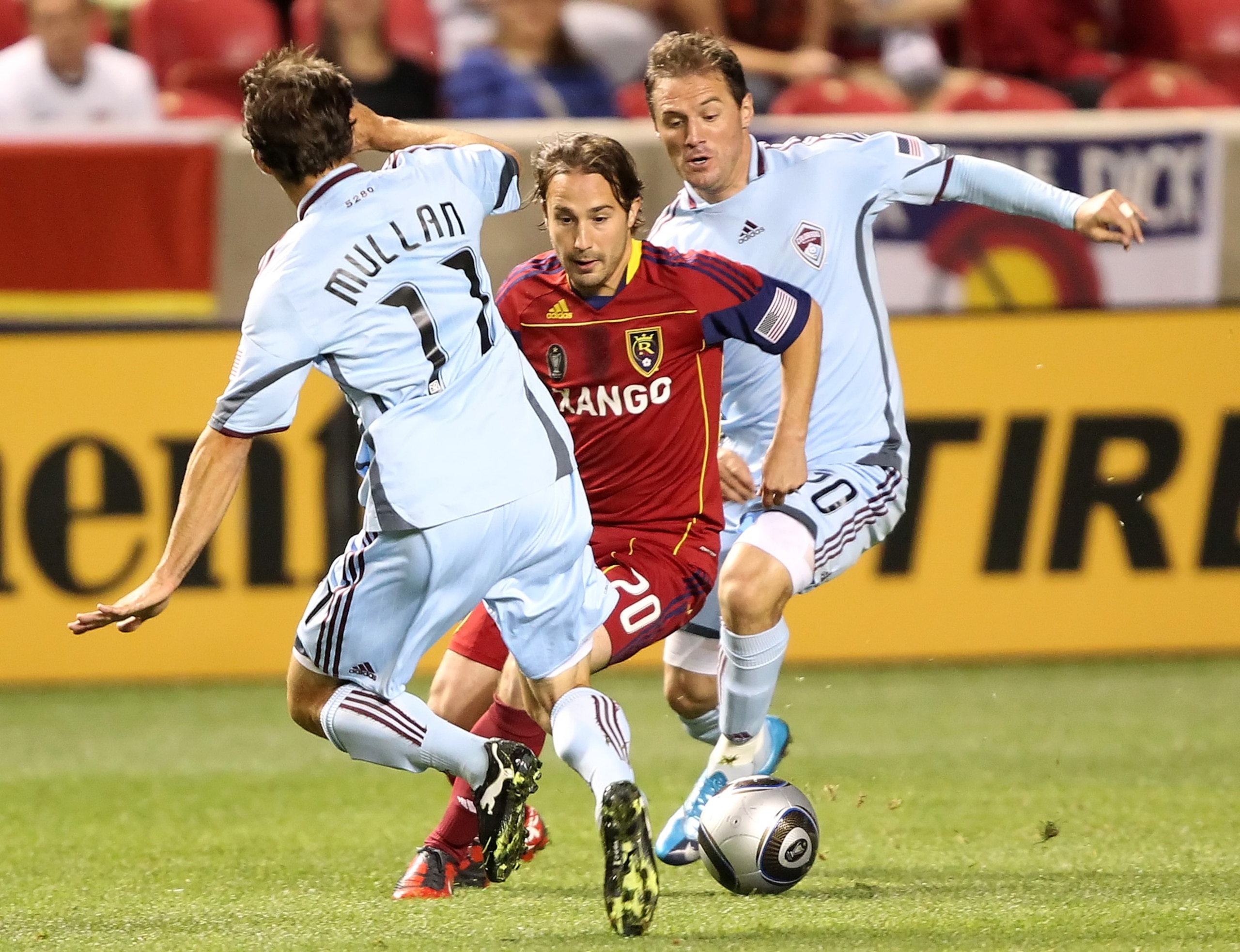 SANDY, UT - SEPTEMBER 25: Ned Grabavoy #20 of Real Salt Lake moves the ball between Brian Mullan #11 and Jamie Smith #20 of the Colorado Rapids during the first half of an MLS soccer game September 25, 2010 at Rio Tinto Stadium in Sandy, Utah. (Photo by G