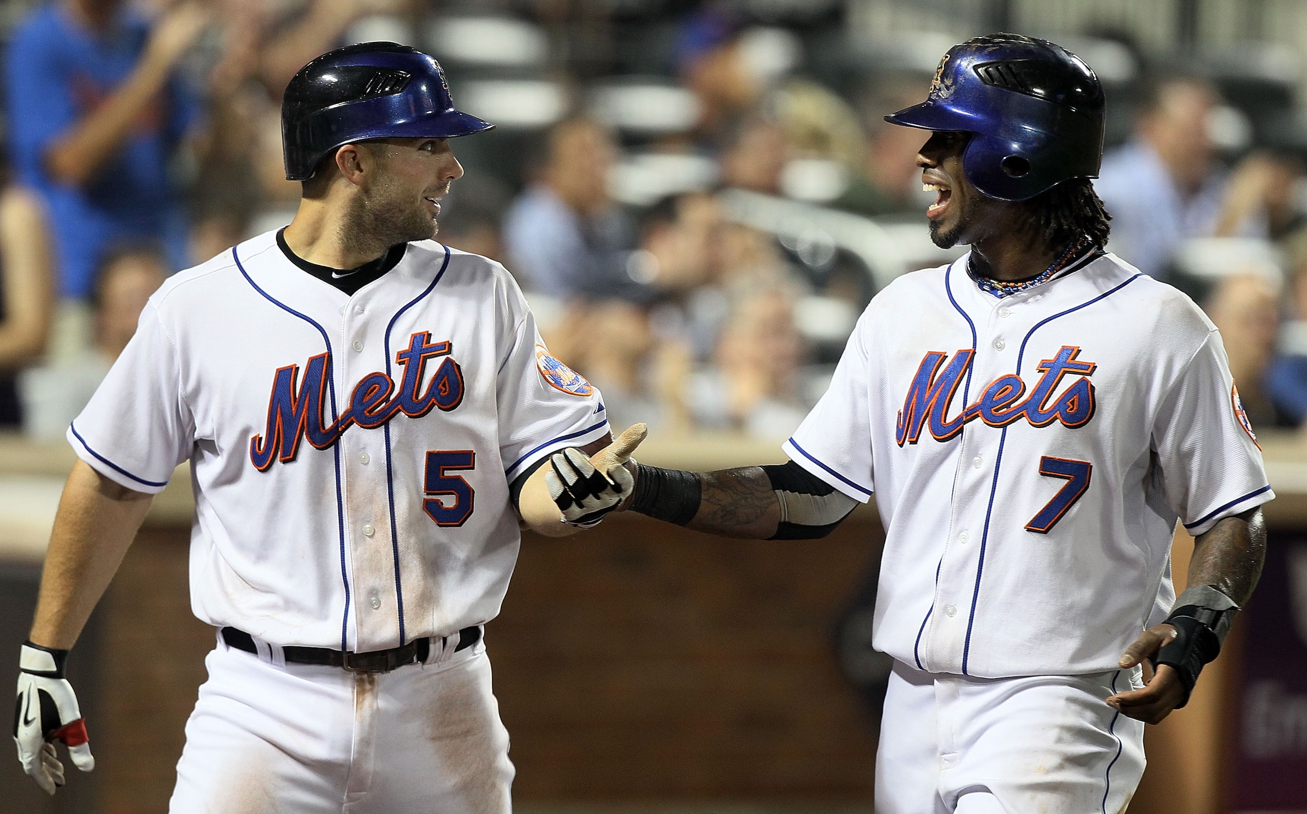 NEW YORK - JULY 06:  Jose Reyes #7 and David Wright #5 of the New York Mets celebrate after scoring in the sixth inning against the Cincinnati Reds on July 6, 2010 at Citi Field in the Flushing neighborhood of the Queens borough of New York City.  (Photo