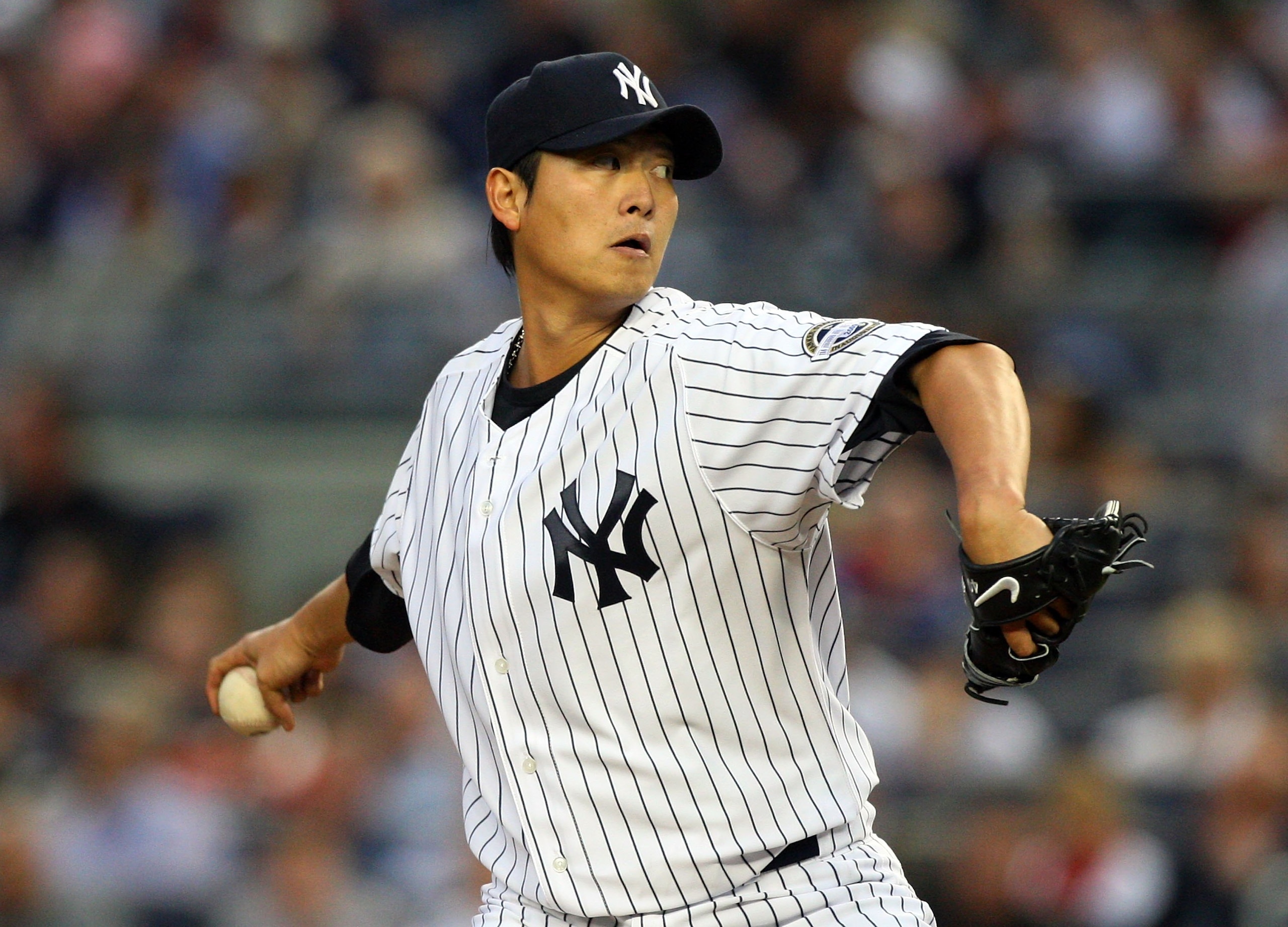 NEW YORK - JUNE 17:  Chien-Ming Wang #40 of the New York Yankees pitches against the Washington Nationals on June 17, 2009 at Yankee Stadium in the Bronx borough of New York City.  (Photo by Jim McIsaac/Getty Images)