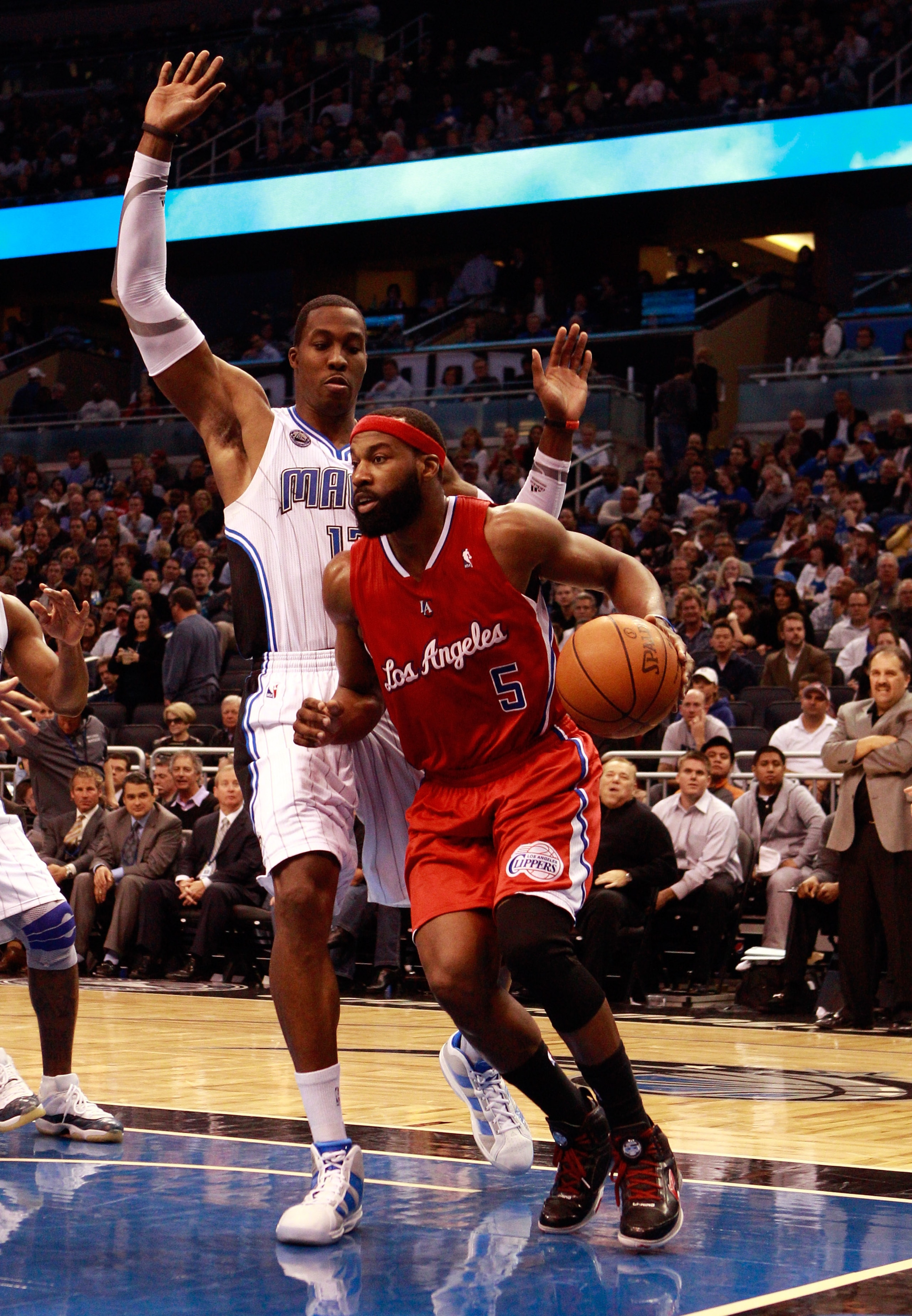 ORLANDO, FL - FEBRUARY 08:  Baron Davis #5 of the Los Angeles Clippers is guarded by Dwight Howard #12 of the Orlando Magic during the game at Amway Arena on February 8, 2011 in Orlando, Florida.  NOTE TO USER: User expressly acknowledges and agrees that,