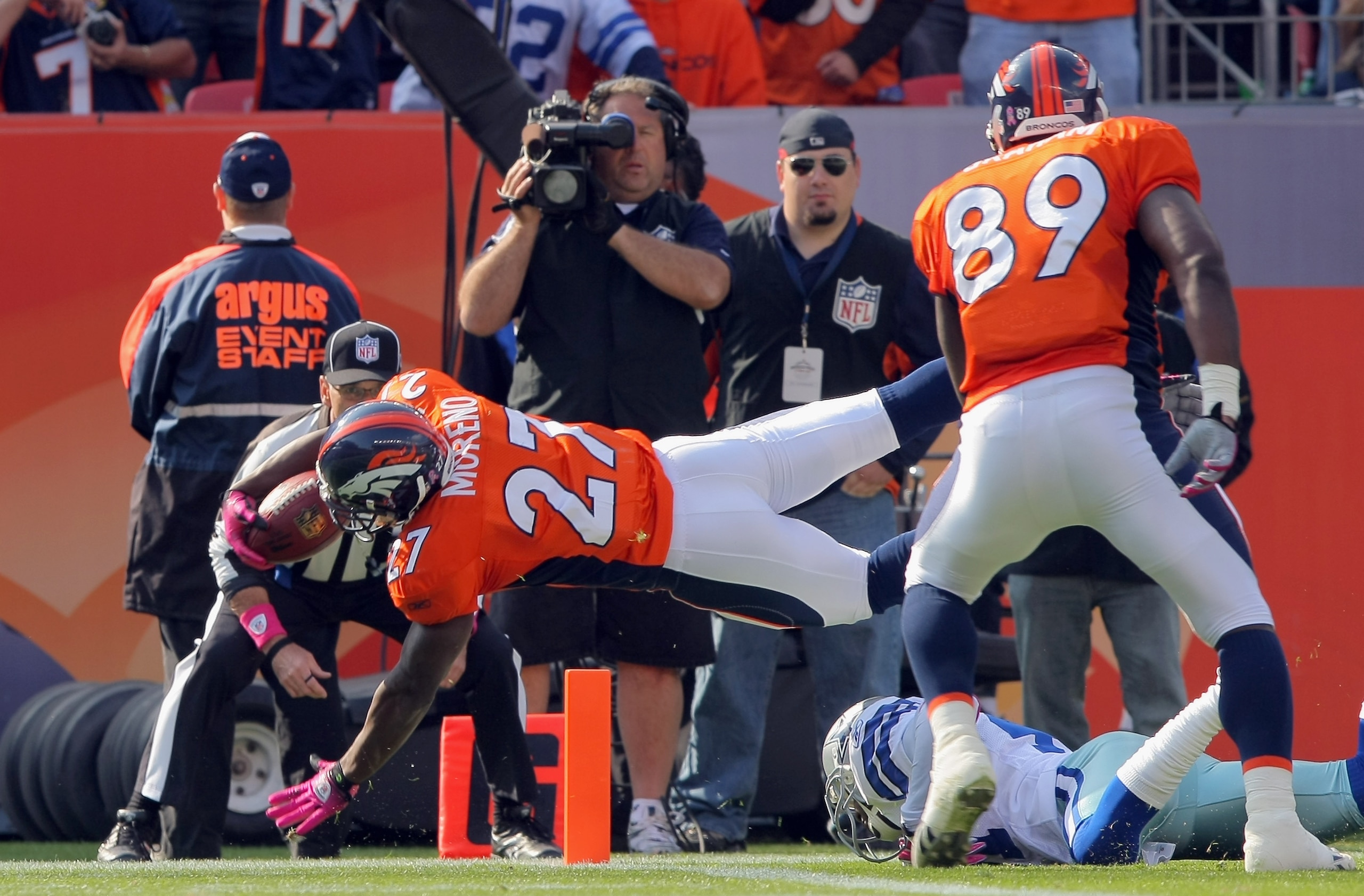 DENVER - OCTOBER 04:  Knowshon Moreno #27 of the Denver Broncos dives into the endzone against the Dallas Cowboys for a second quarter touchdown during NFL action at Invesco Field at Mile High on October 4, 2009 in Denver, Colorado.  (Photo by Doug Pensin