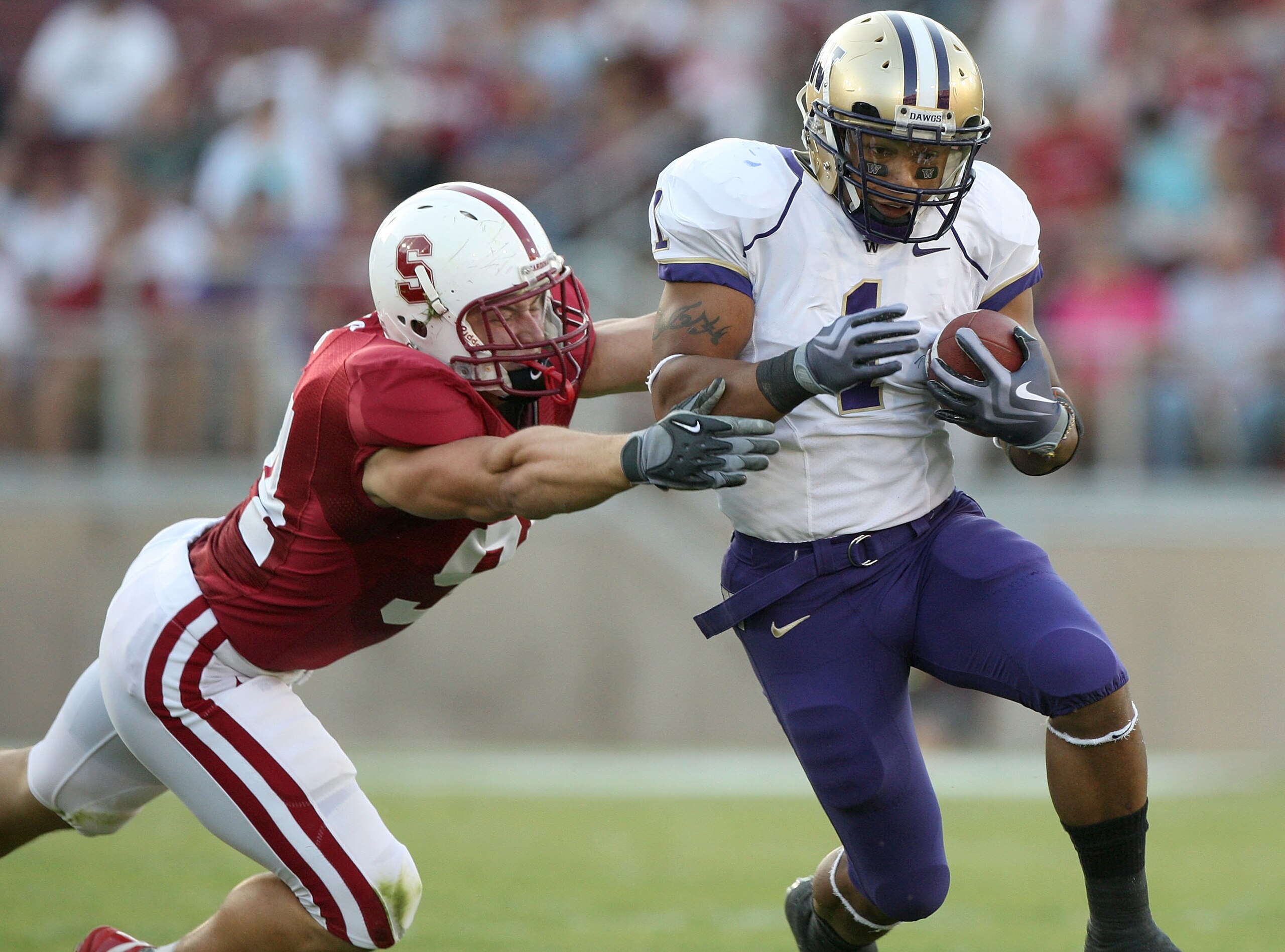 PALO ALTO, CA - SEPTEMBER 26:  Chris Polk #1 of the Washington Huskies runs against Thomas Keiser #94 of the Stanford Cardinal at Stanford Stadium on September 26, 2009 in Palo Alto, California.  (Photo by Jed Jacobsohn/Getty Images)