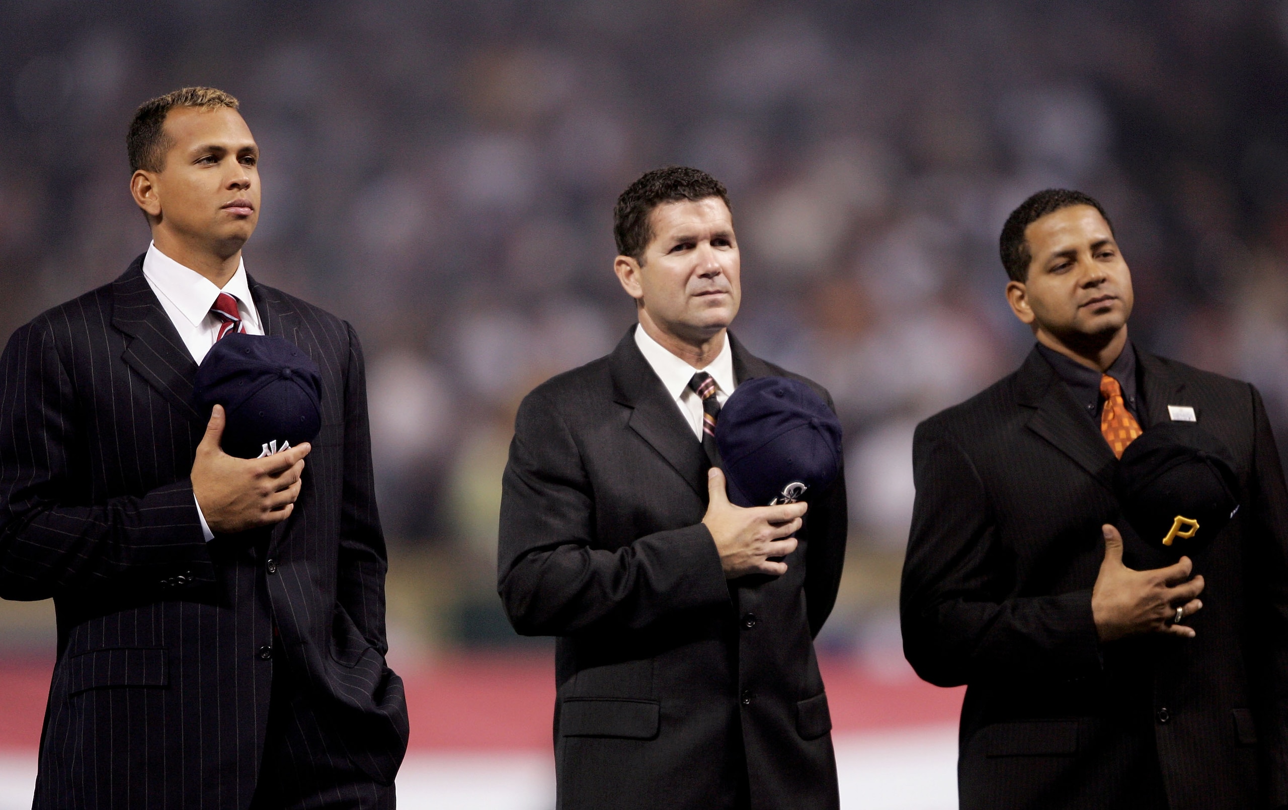 HOUSTON - OCTOBER 26:  Members of the Major League Baseball Latino Legends Team; (L-R) Alex Rodriguez, Edgar Martinez and Roberto Clemente Jr. stand attended during the National Anthem of Game Four of the 2005 Major League Baseball World Series between th