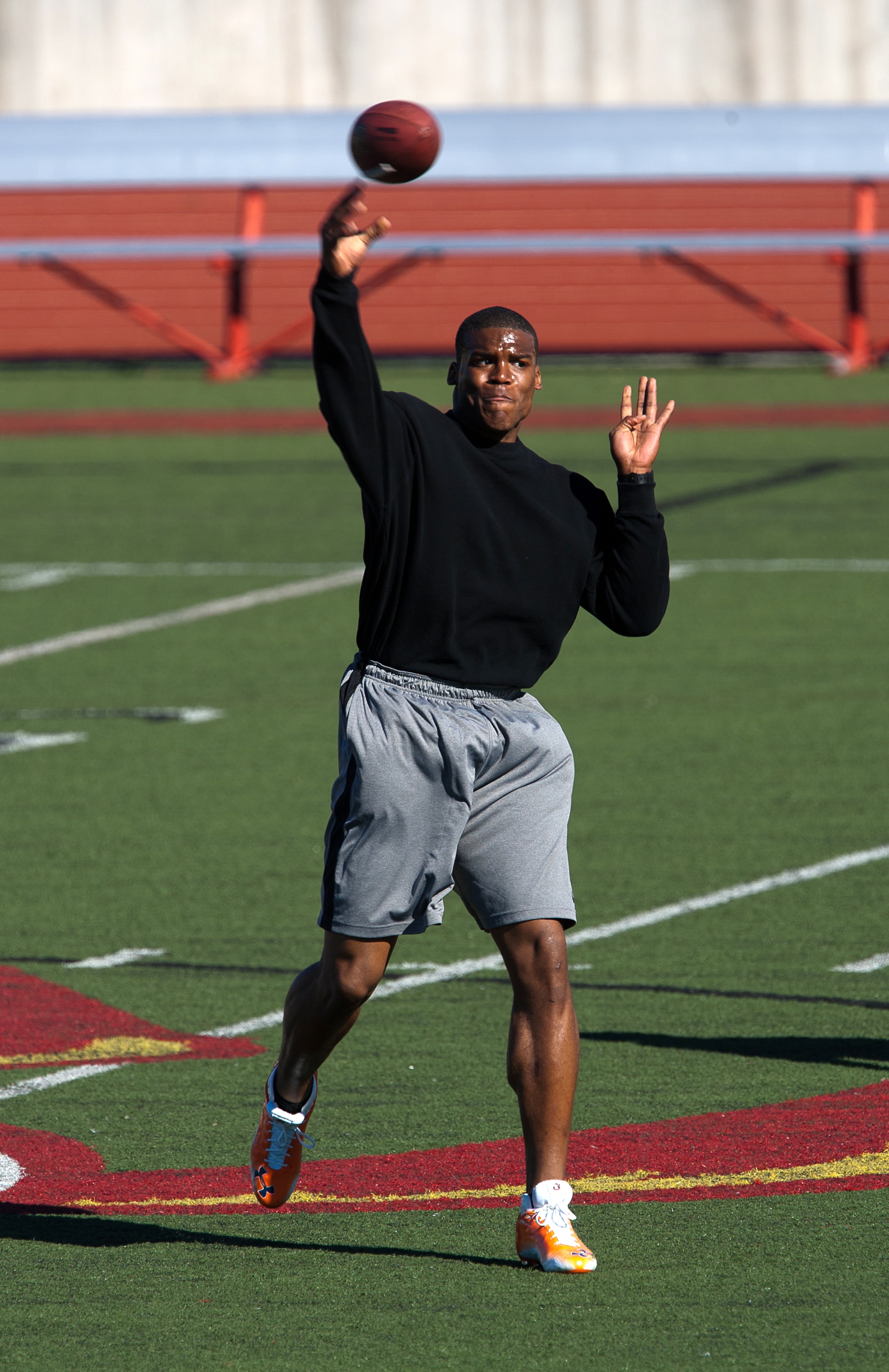 SAN DIEGO, CA - FEBRUARY 10:  2010 Heisman Trophy winning quarterback Cam Newton of the Auburn Tigers goes through his workout routine for the media at Cathedral High School's sports stadium on February 10, 2011 in San Diego, California.  (Photo by Kent H