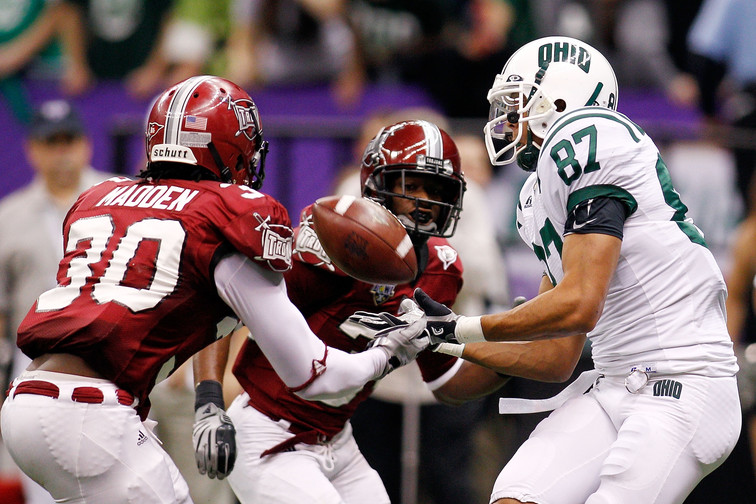 NEW ORLEANS, LA - DECEMBER 18:  Steven Goulet #87 of the Ohio University Bobcats catches a touchdown pass over Ladarrius Madden #30 of the Troy University Trojans during the R&L Carriers New Orleans Bowl at the Louisiana Superdome on December 18, 2010 in