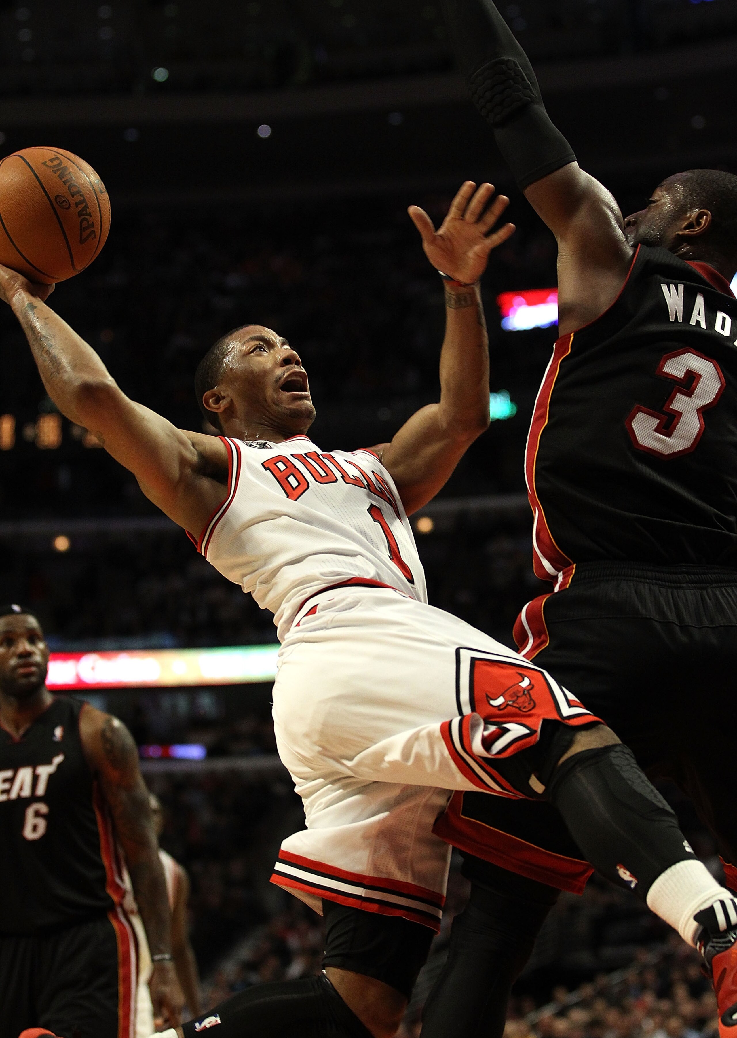 CHICAGO, IL - FEBRUARY 24: Derrick Rose #1 of the Chicago Bulls puts up a shot against Dwyane Wade #3 of the Miami Heat at the United Center on February 24, 2011 in Chicago, Illinois. The Bulls defeated the Heat 93-89. NOTE TO USER: User expressly acknowl