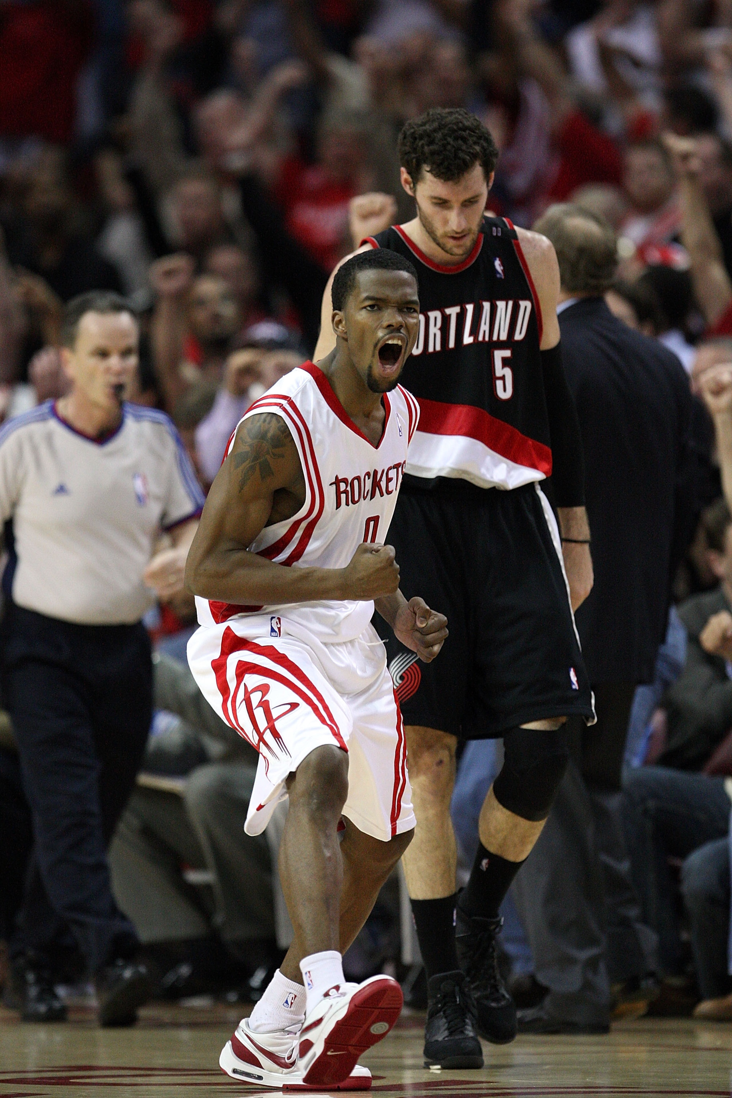 HOUSTON - APRIL 30:  Guard Aaron Brooks #0 of the Houston Rockets reacts after making a three-point shot in front of Rudy Fernandez #5 of the Portland Trail Blazers in Game Six of the Western Conference Quarterfinals during the 2009 NBA Playoffs at Toyota