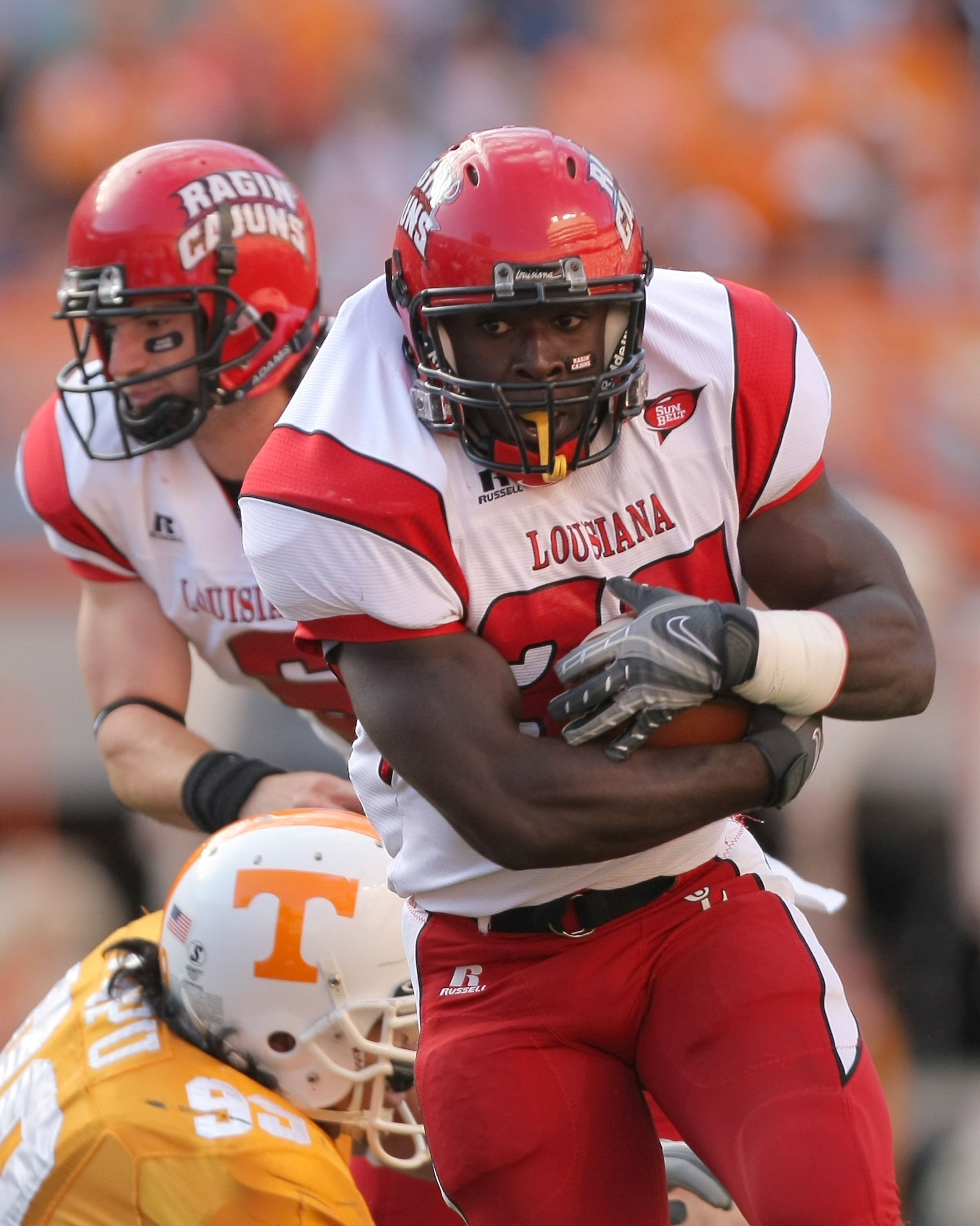 KNOXVILLE, TN - NOVEMBER 03:  Geoffrey McCullough #34 of the Louisiana Lafayette Cajuns rushes after a handoff from Michael Desormeaux #6 past J.T. Mapu #99 of the Tennessee Volunteers at Neyland Stadium on November 3, 2007 in Knoxville, Tennessee.  (Phot