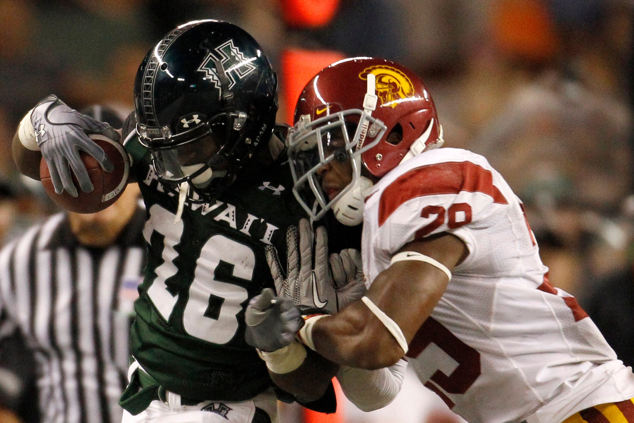 HONOLULU - SEPTEMBER 02:  Chizzy Dimude #26 of the University of Hawaii Warriors is forced out of bounds by Jawanza Starling #29 of the University of Southern California Trojans during second half action at Aloha Stadium September 2, 2010 in Honolulu, Haw