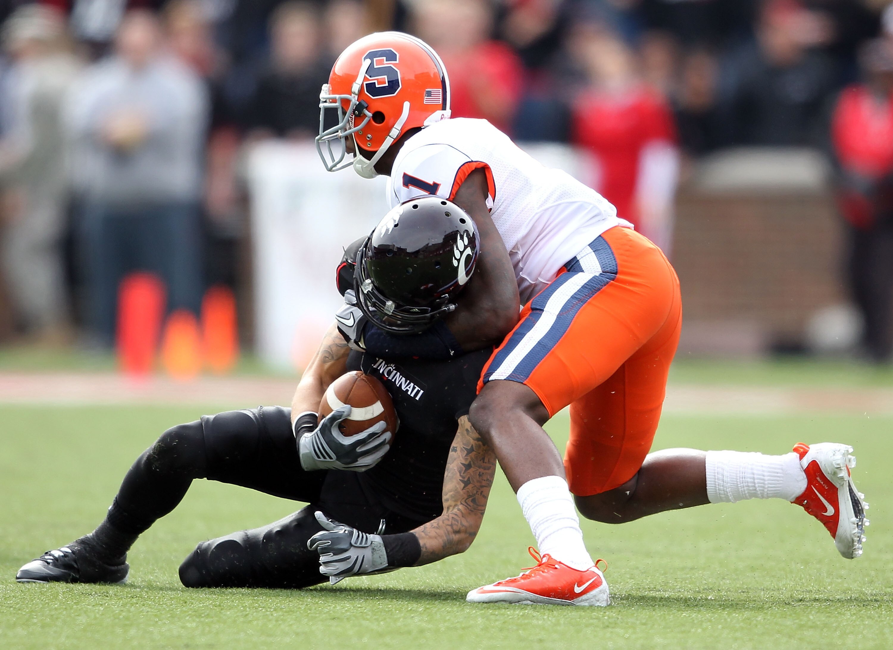 CINCINNATI - OCTOBER 30:  D J Woods #3 of the Cincinnati Bearcats is tackled by Phillip Thomas #1 of the Syracuse Orange during the Big East Conference game at Nippert Stadium on October 30, 2010 in Cincinnati, Ohio.  (Photo by Andy Lyons/Getty Images)