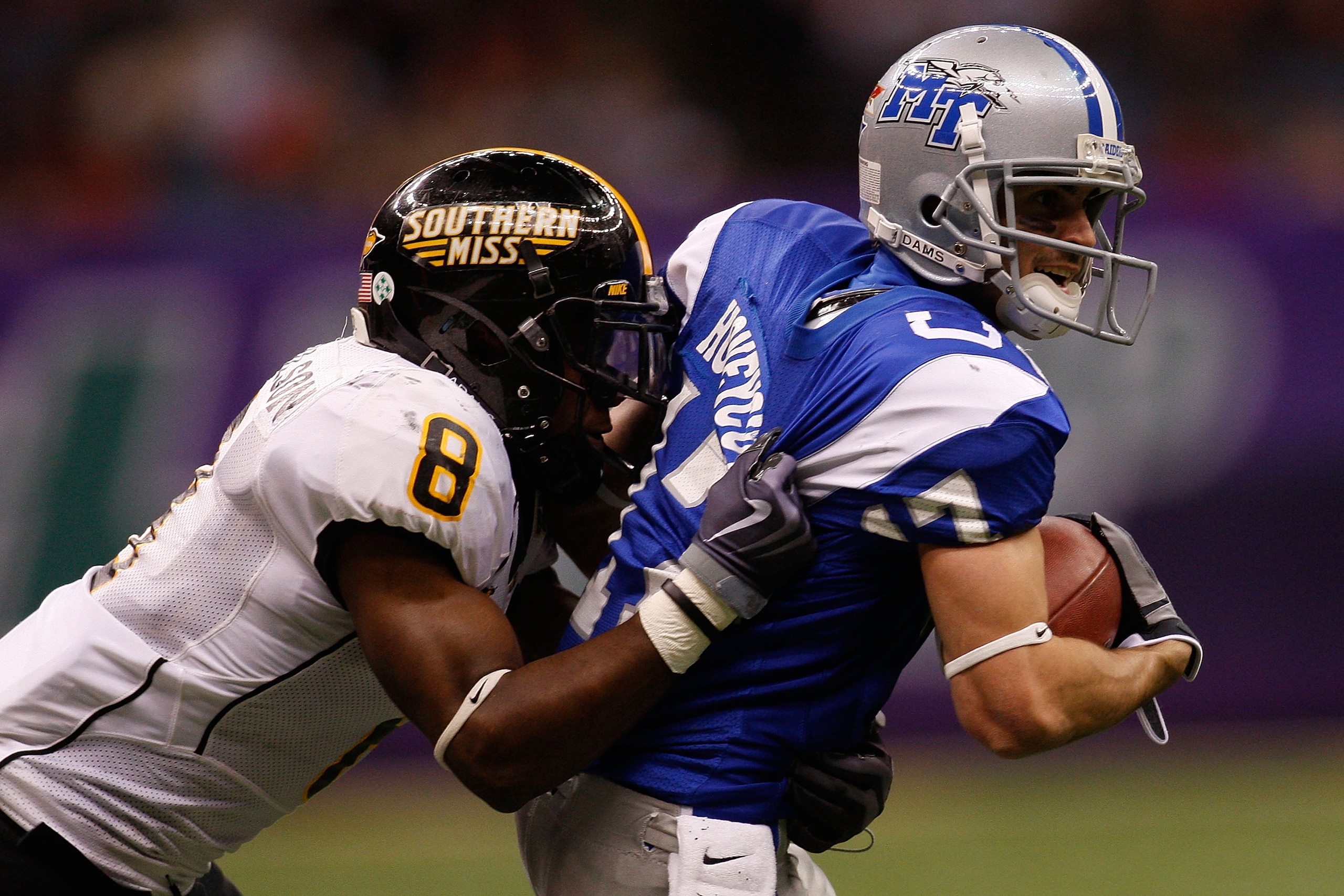 NEW ORLEANS - DECEMBER 20:  Patrick Honeycutt #17 of the Middle Tennessee Blue Raiders is tackled by Justin Wilson #8 of the Southern Miss Golden Eagles  during the R+L Carriers New Orleans Bowl at the Louisiana Superdome on December 20, 2009 in New Orlea