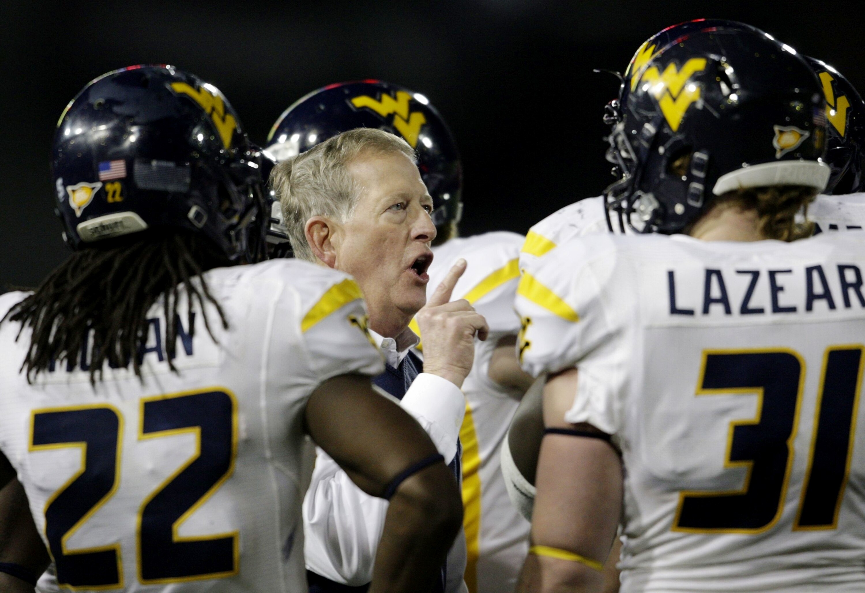 CINCINNATI - NOVEMBER 13:  Head coach Bill Stewart of the West Virginia Mountaineers meets with his team in the fourth quarter of the game against the Cincinnati Bearcats at Nippert Stadium on November 13, 2009 in Cincinnati, Ohio.  (Photo by Andy Lyons/G