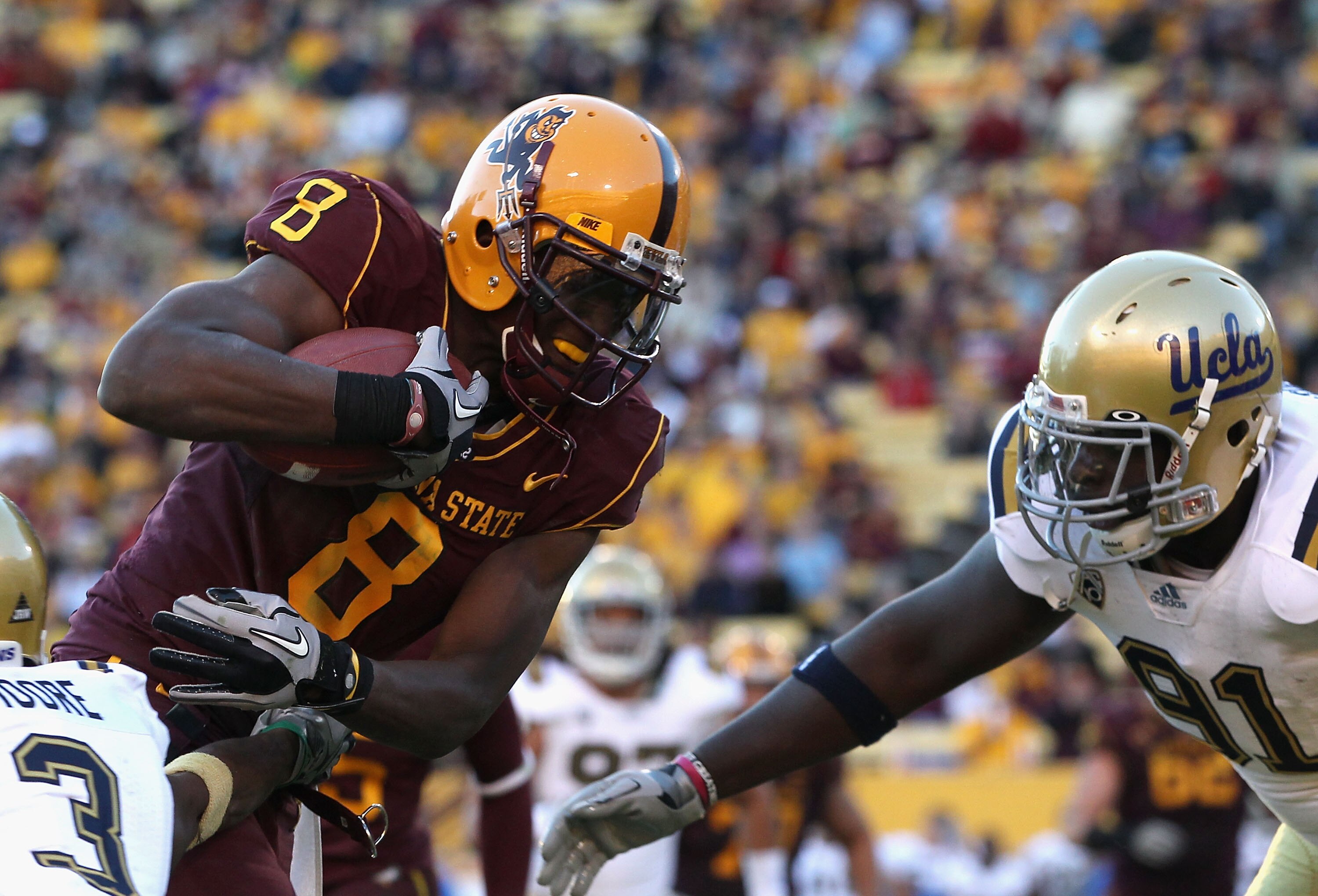 TEMPE, AZ - NOVEMBER 26:  Wide reciever Gerell Robinson #8 of the Arizona State Sun Devils runs with the football after a reception against the UCLA Bruins during the college football game at Sun Devil Stadium on November 26, 2010 in Tempe, Arizona.  The 