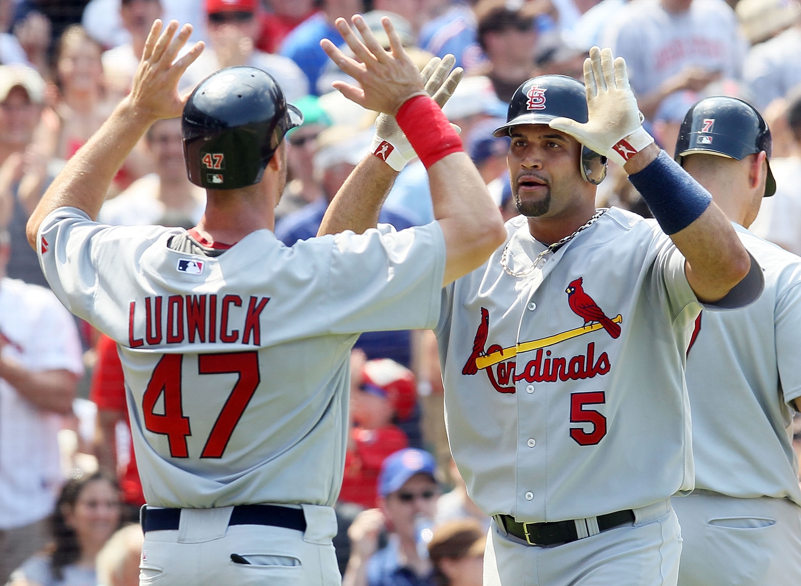 CHICAGO, IL - MAY 30:  Albert Pujols #5 of the St. Louis Cardinals celebrates his fifth inning two run home run against the Chicago Cubs with teammate Ryan Ludwick #47 on May 30, 2010 at Wrigley Field in Chicago, Illinois.  (Photo by Jim McIsaac/Getty Ima