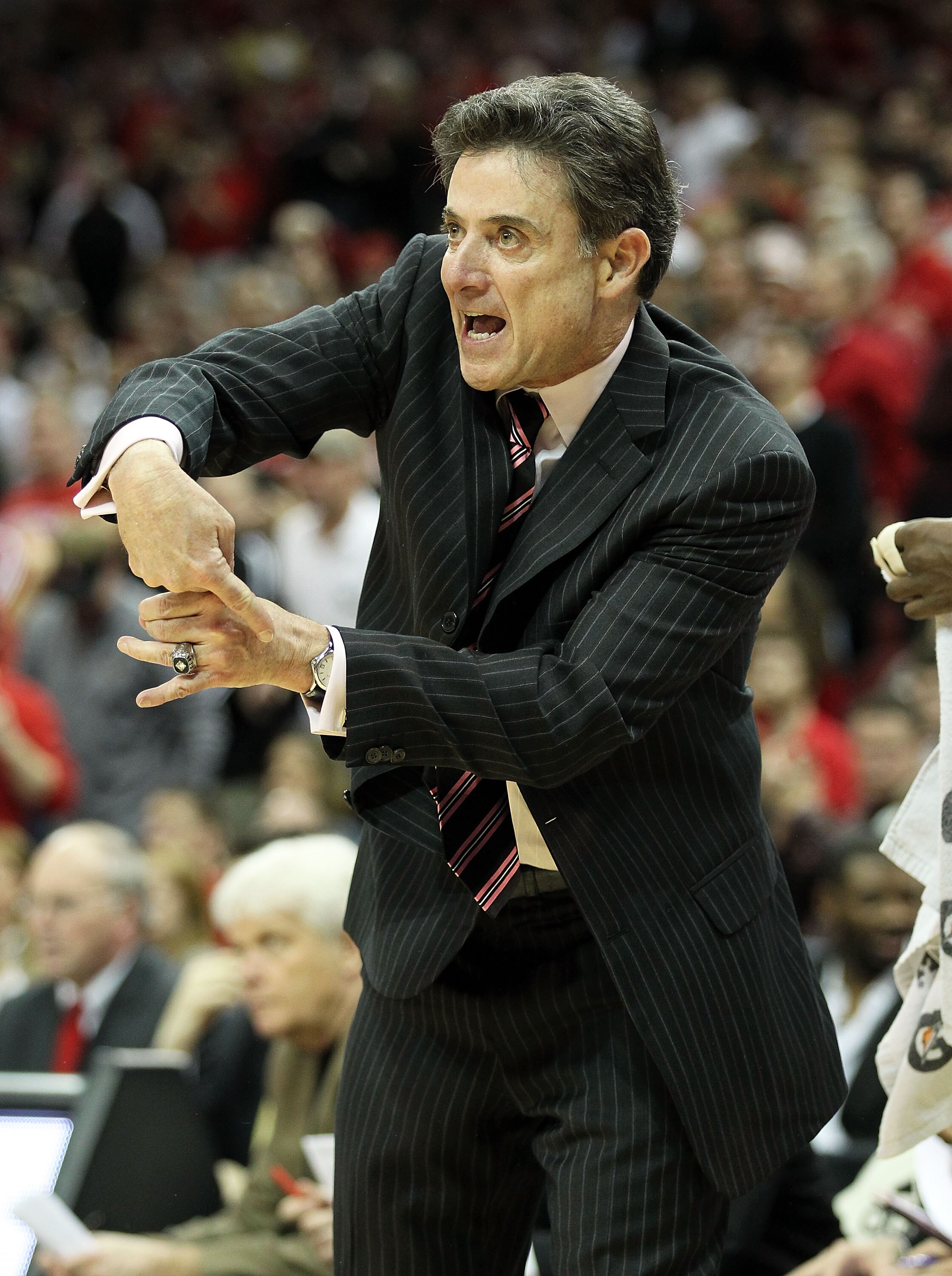 LOUISVILLE, KY - FEBRUARY 18:  Head coach Rick Pitino of the Louisville Cardinals gives instructions to his team during the Big East Conference game against the Connecticut Huskies at the KFC Yum! Center on February 18, 2011 in Louisville, Kentucky.  (Pho