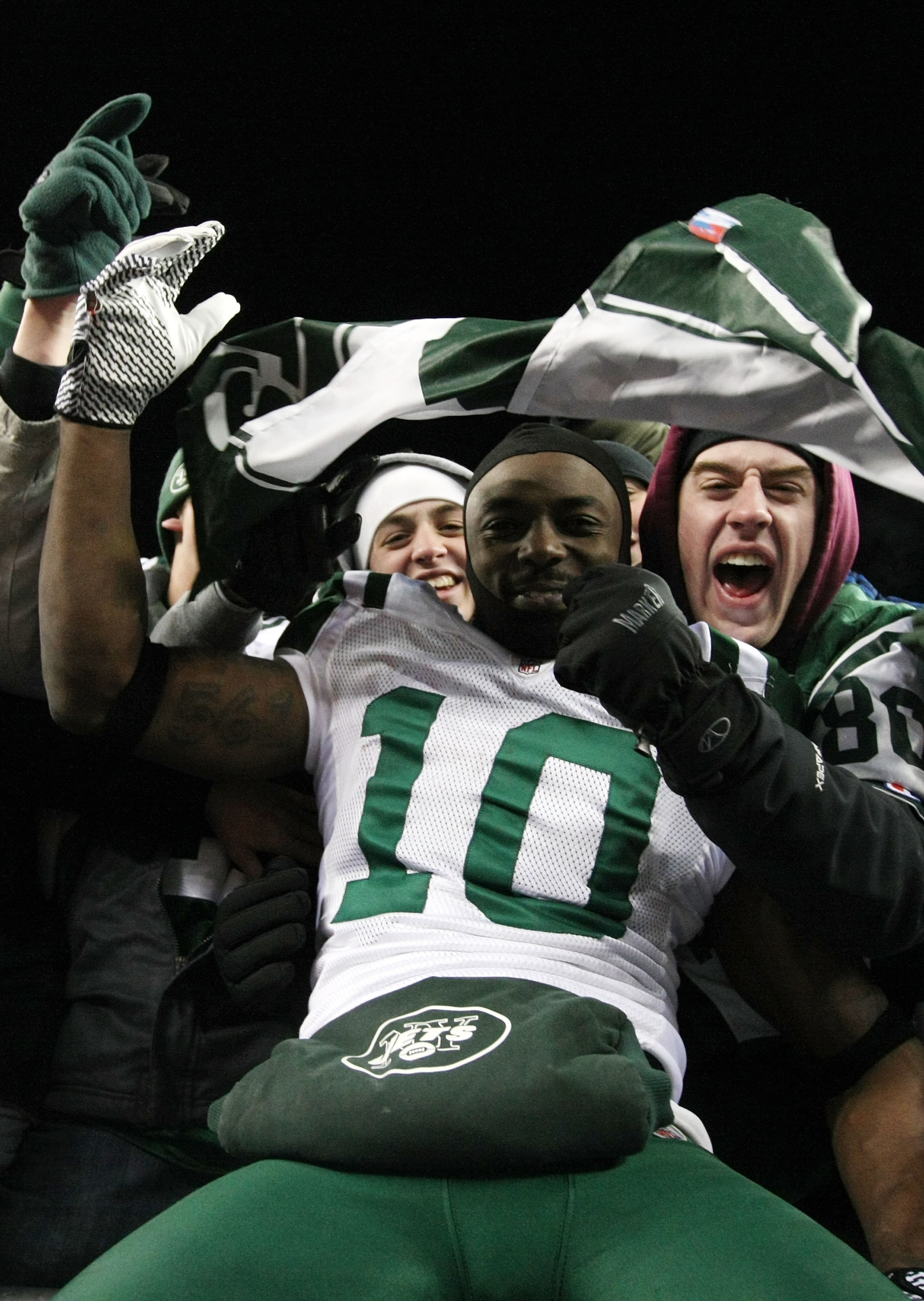 FOXBORO, MA - JANUARY 16:  Santonio Holmes #10 of the New York Jets celebrates with fans after the Jets defeated the Patriots 28 to 21 in their 2011 AFC divisional playoff game at Gillette Stadium on January 16, 2011 in Foxboro, Massachusetts.  (Photo by