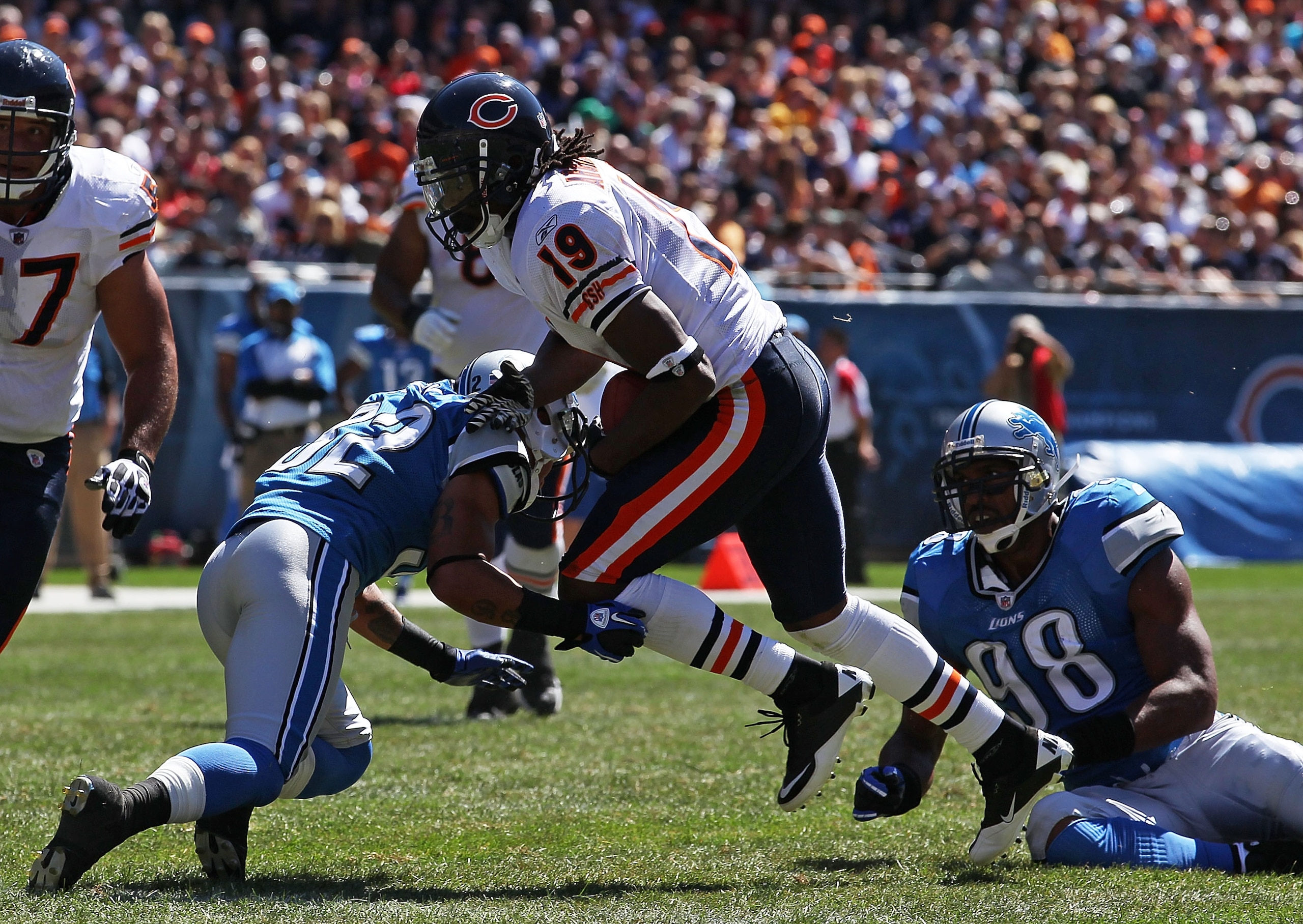 CHICAGO - SEPTEMBER 12: Devin Aromashodu #19 of the Chicago Bears is hit by Aaron Berry #32 of the Detroit Lions after a catch during the NFL season opening game at Soldier Field on September 12, 2010 in Chicago, Illinois. The Bears defeated the Lions 19-