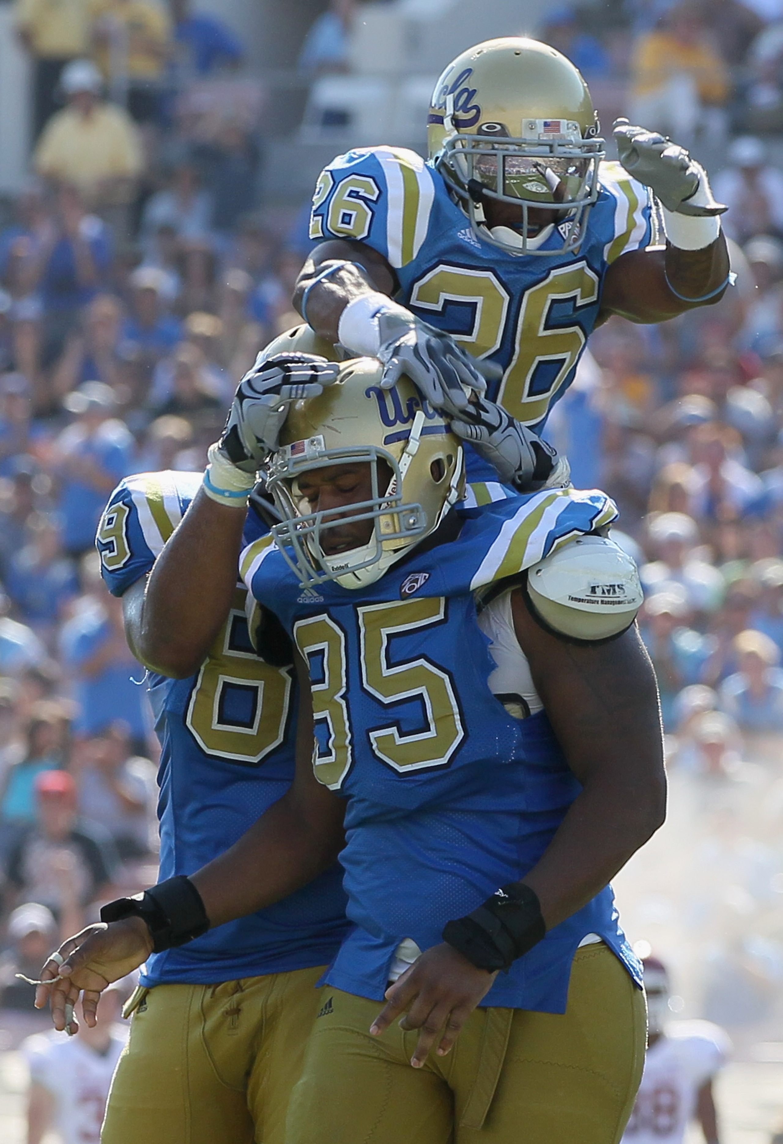 PASADENA, CA - OCTOBER 02: Andrew Abbott #26 of the UCLA Bruins jumps onto the shoulders of teammate David Carter #85 after Carter's sack of Washington State quarterback Jeff Tuel during the fourth quarter at the Rose Bowl on October 2, 2010 in Pasadena PASADENA, CA - OCTOBER 02: Andrew Abbott #26 of the UCLA Bruins jumps onto the shoulders of teammate David Carter #85 after Carter's sack of Washington State quarterback Jeff Tuel during the fourth quarter at the Rose Bowl on October 2, 2010 in Pasadena