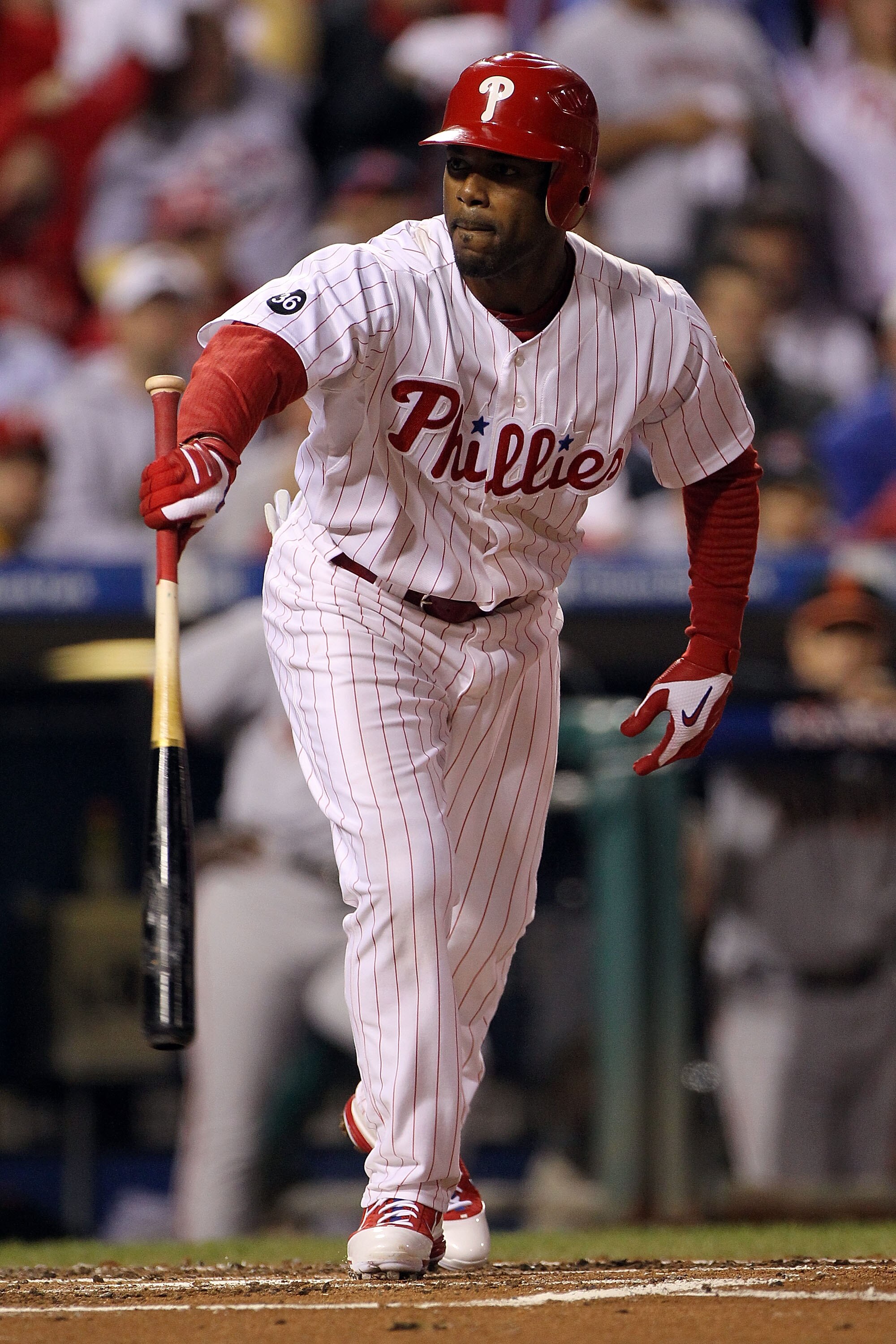PHILADELPHIA - OCTOBER 17:  Jimmy Rollins #11 of the Philadelphia Phillies walks with the bases loaded to score Chase Utley #26 in the first inning against the San Francisco Giants in Game Two of the NLCS during the 2010 MLB Playoffs at Citizens Bank Park