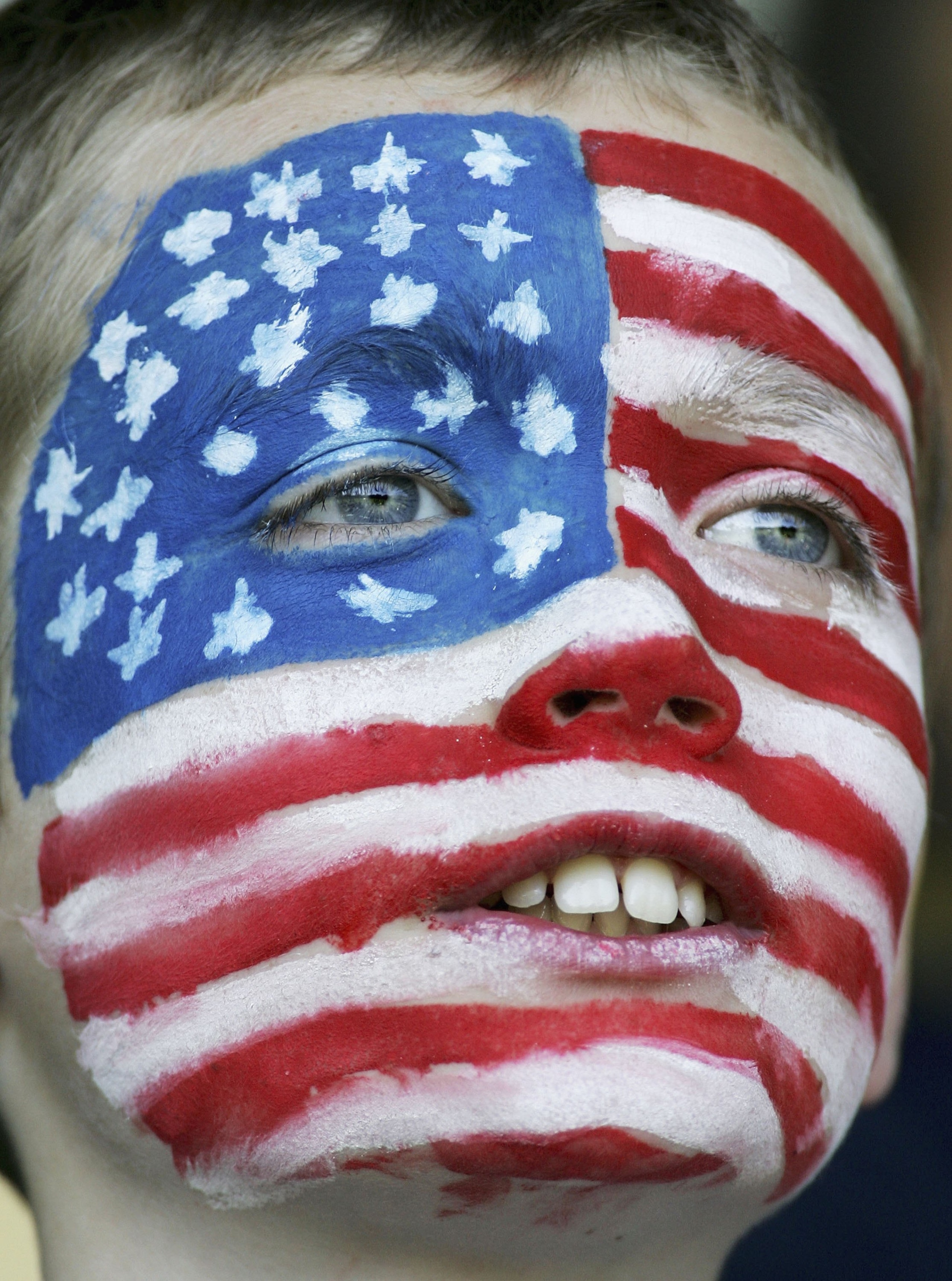 NORDERSTEDT, GERMANY - JUNE 06:  A young USA fan watches during a training session for the United States National Team on June 6, 2006 at Edmund Plambeck Stadium in Norderstedt, Germany.  (Photo by Jonathan Ferrey/Getty Images)