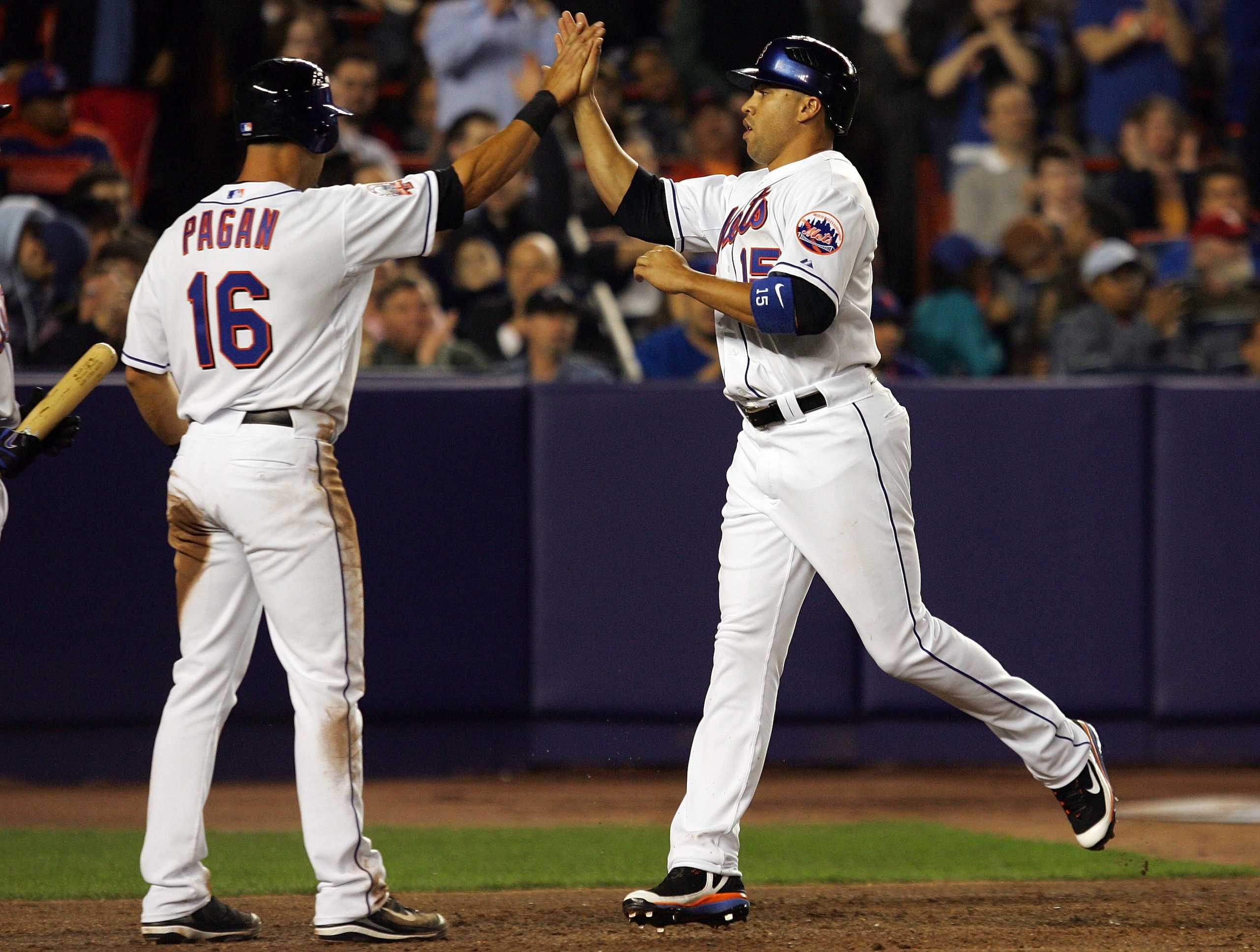 NEW YORK - APRIL 10: Carlos Beltran #15 and Angel Pagan #16 of the New York Mets celebrate aftrer scoring in the fourth inning against the Philadelphia Phillies on April 10, 2008 at Shea Stadium in the Flushing neighborhood of the Queens borough of New Yo